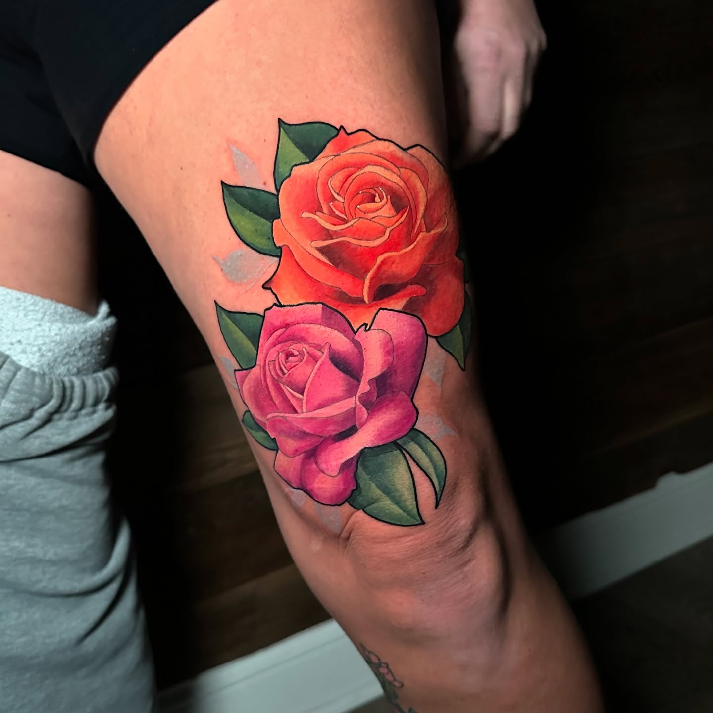 Roses American traditional tattoo on the thigh by Joe Friedman