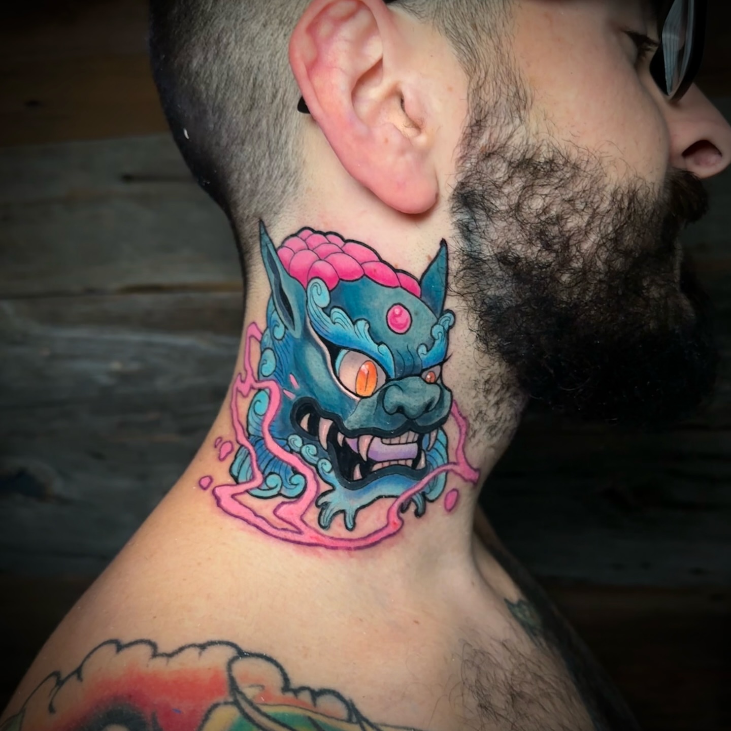 Monster head new school tattoo on the neck by Joe Friedman