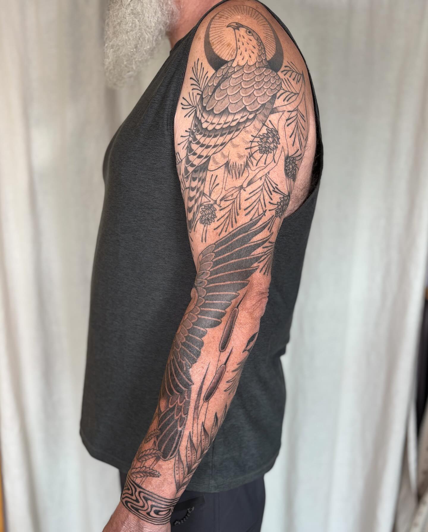 Bird and pinecone American traditional tattoo on the upper arm by Anna Sage