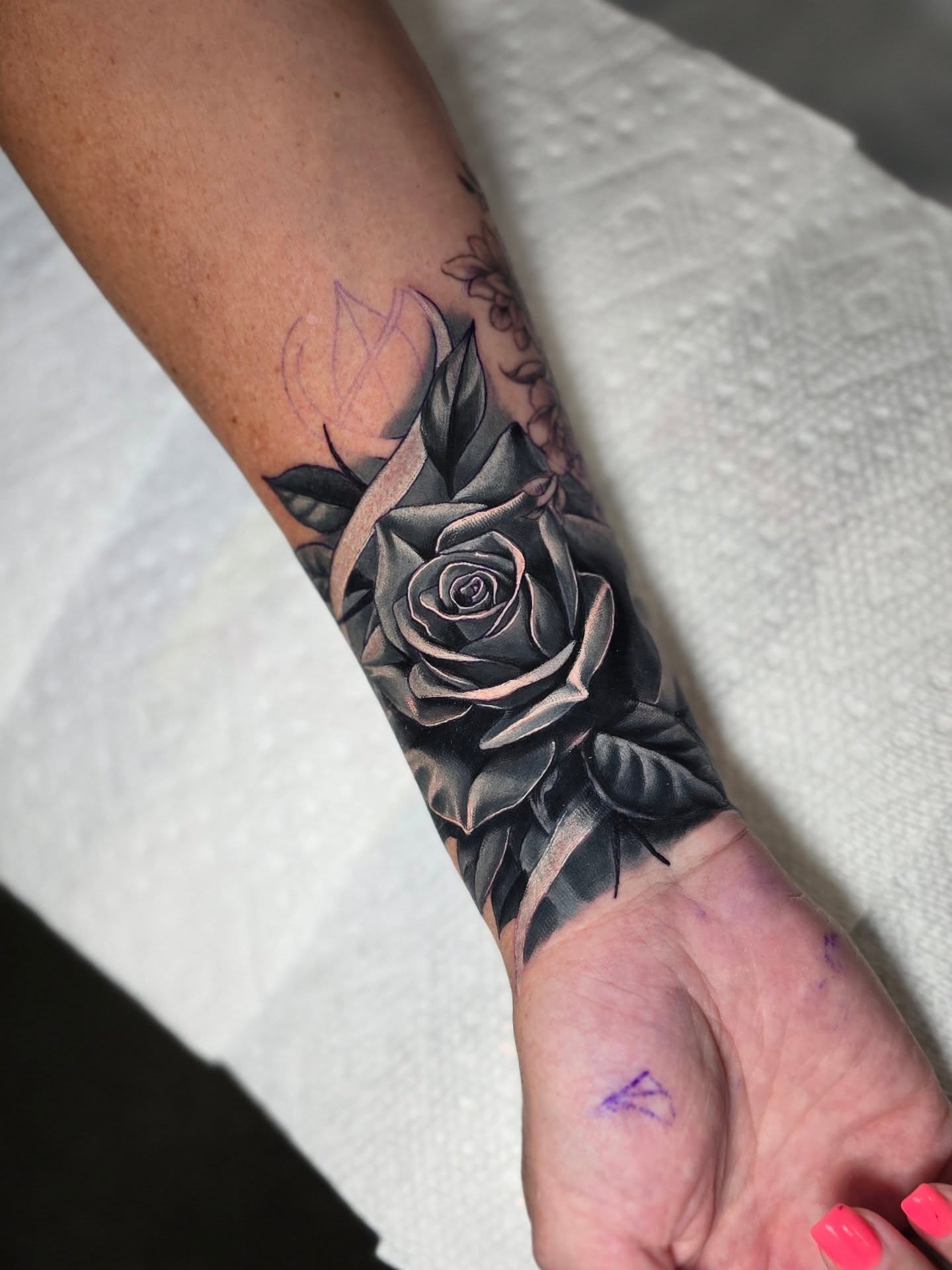Rose realism tattoo on the forearm by Myth & Mercy Tattoo Co.