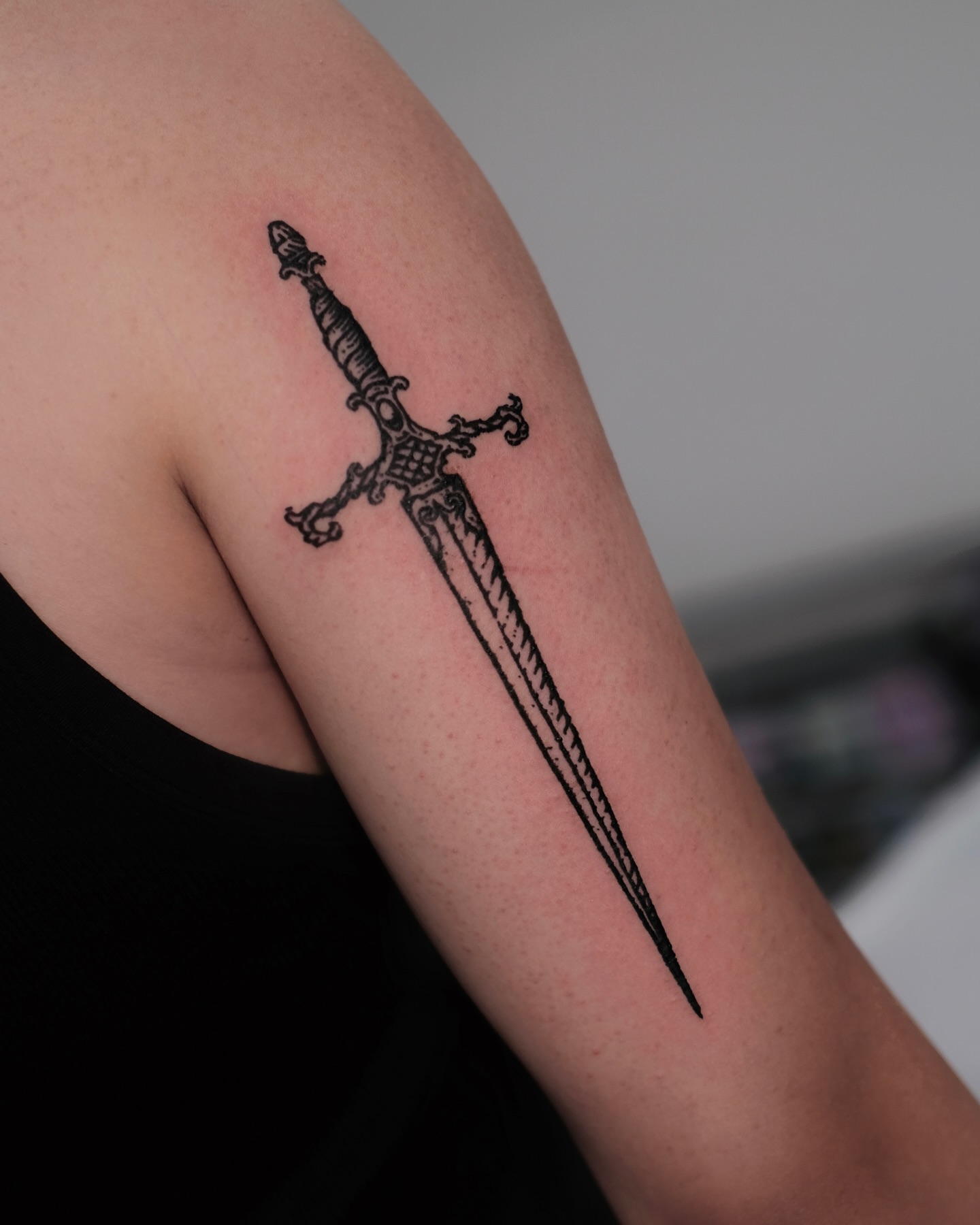 Sword black and grey tattoo on the forearm by ꜰʟᴏʀᴀ ᴡᴏᴏᴅᴄᴜᴛ ᴛᴀᴛᴛᴏᴏ