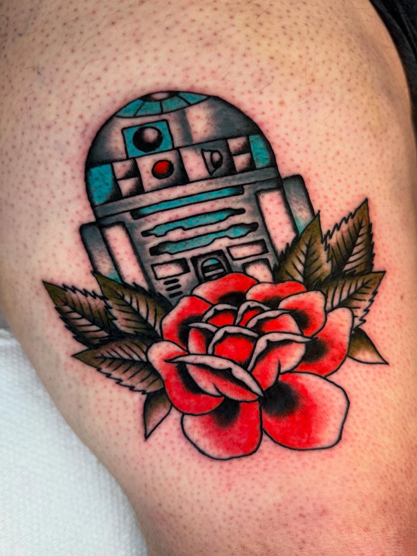 R2-D2 and rose American traditional tattoo on the shoulder by Cody Petkus
