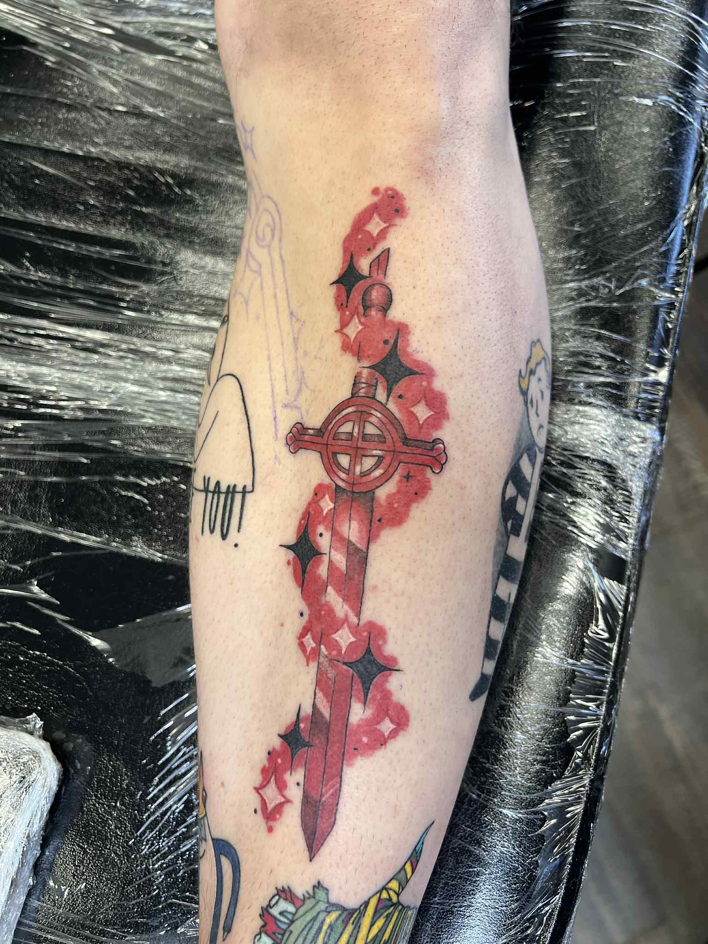 Sword with blood American traditional tattoo on the forearm by Erin Moore