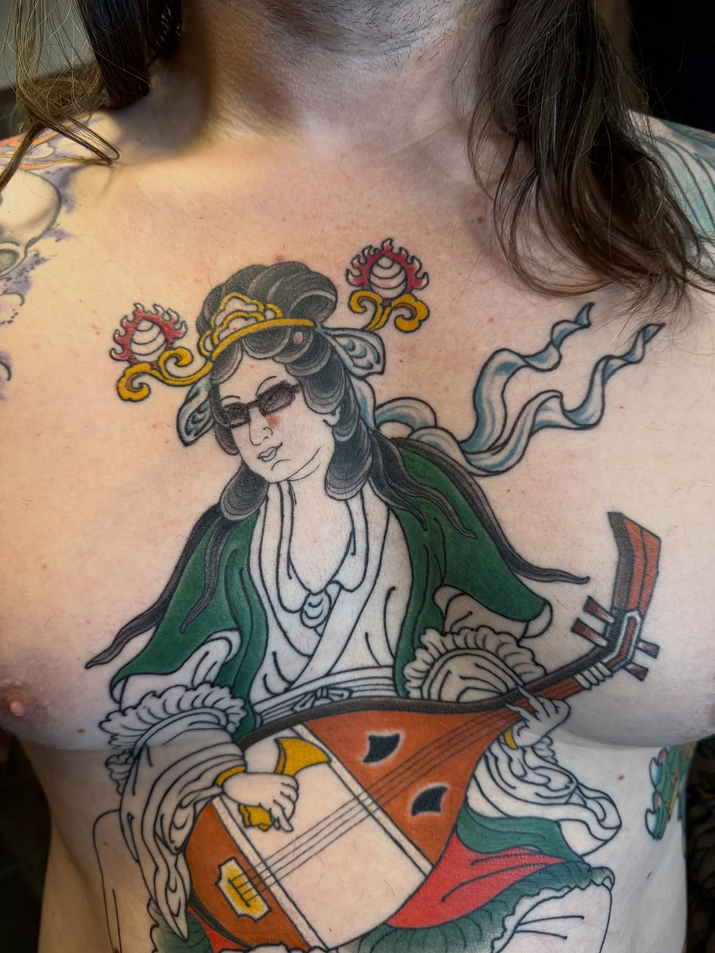 Geisha playing string instrument japanese irezumi tattoo on the chest by Candi Kinyōbi