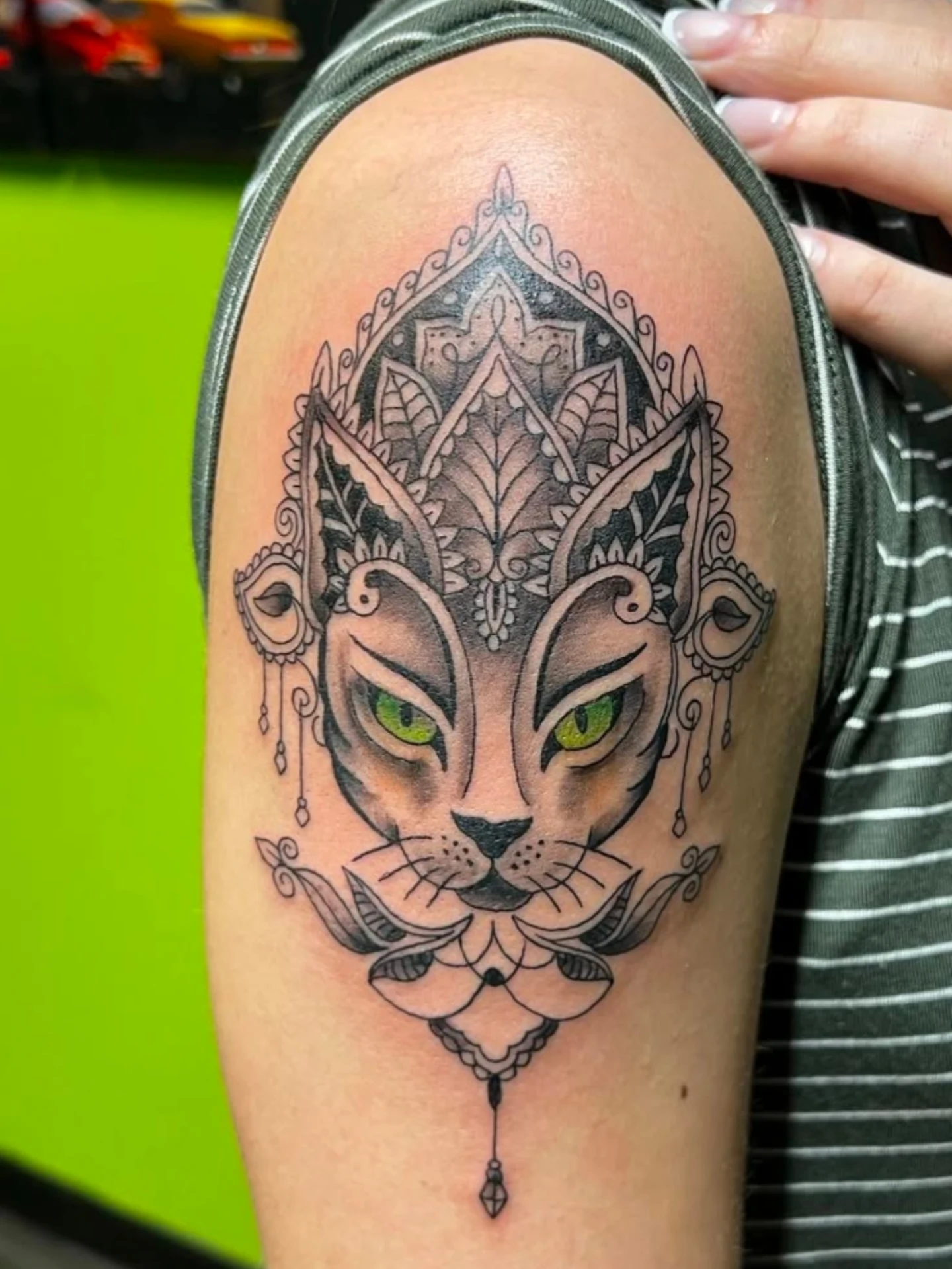 Cat ornamental tattoo on the shoulder by William “Shamrock” Sammon