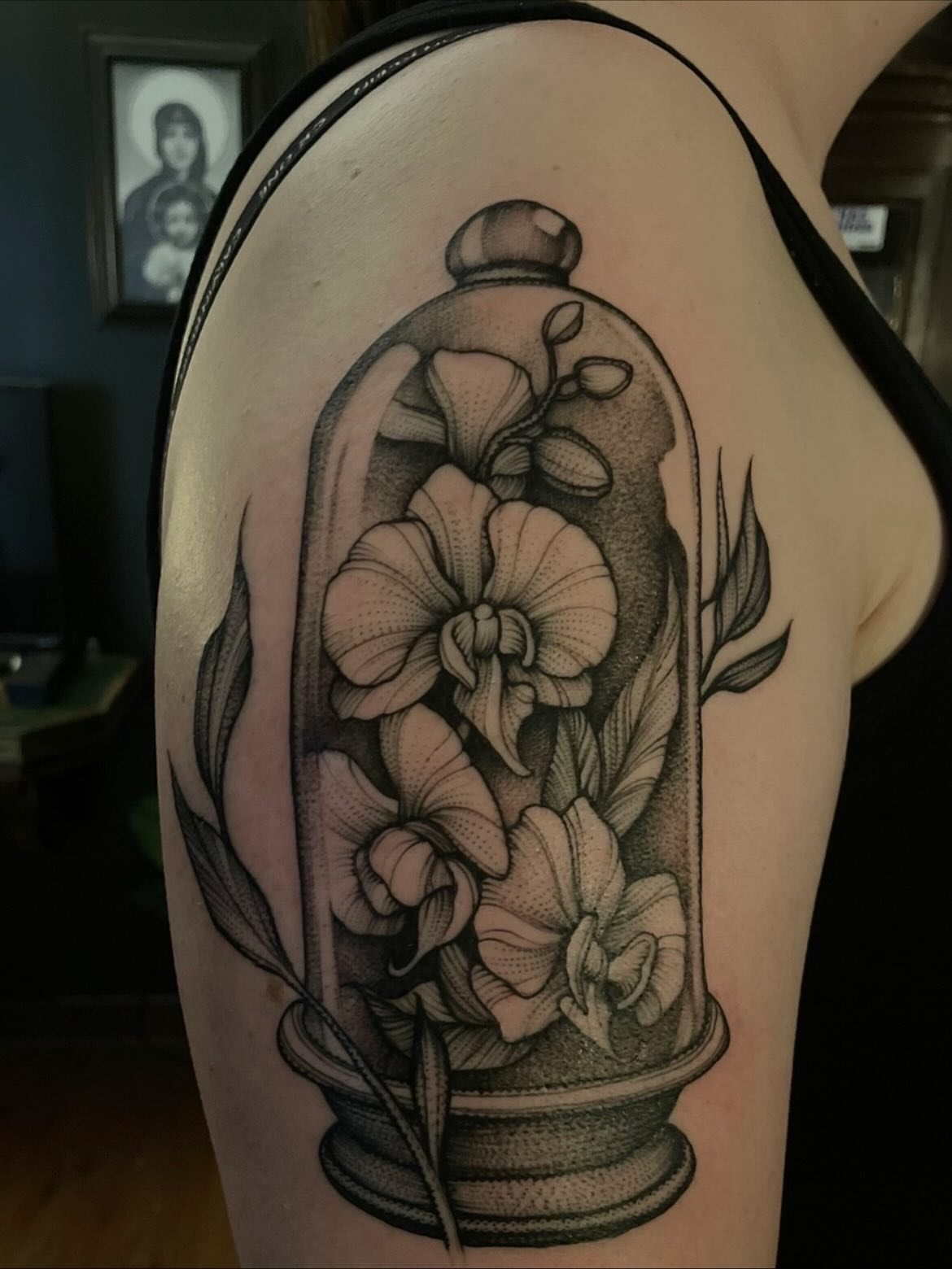 Glass dome with flowers realism tattoo on the shoulder by Jacob Kearney