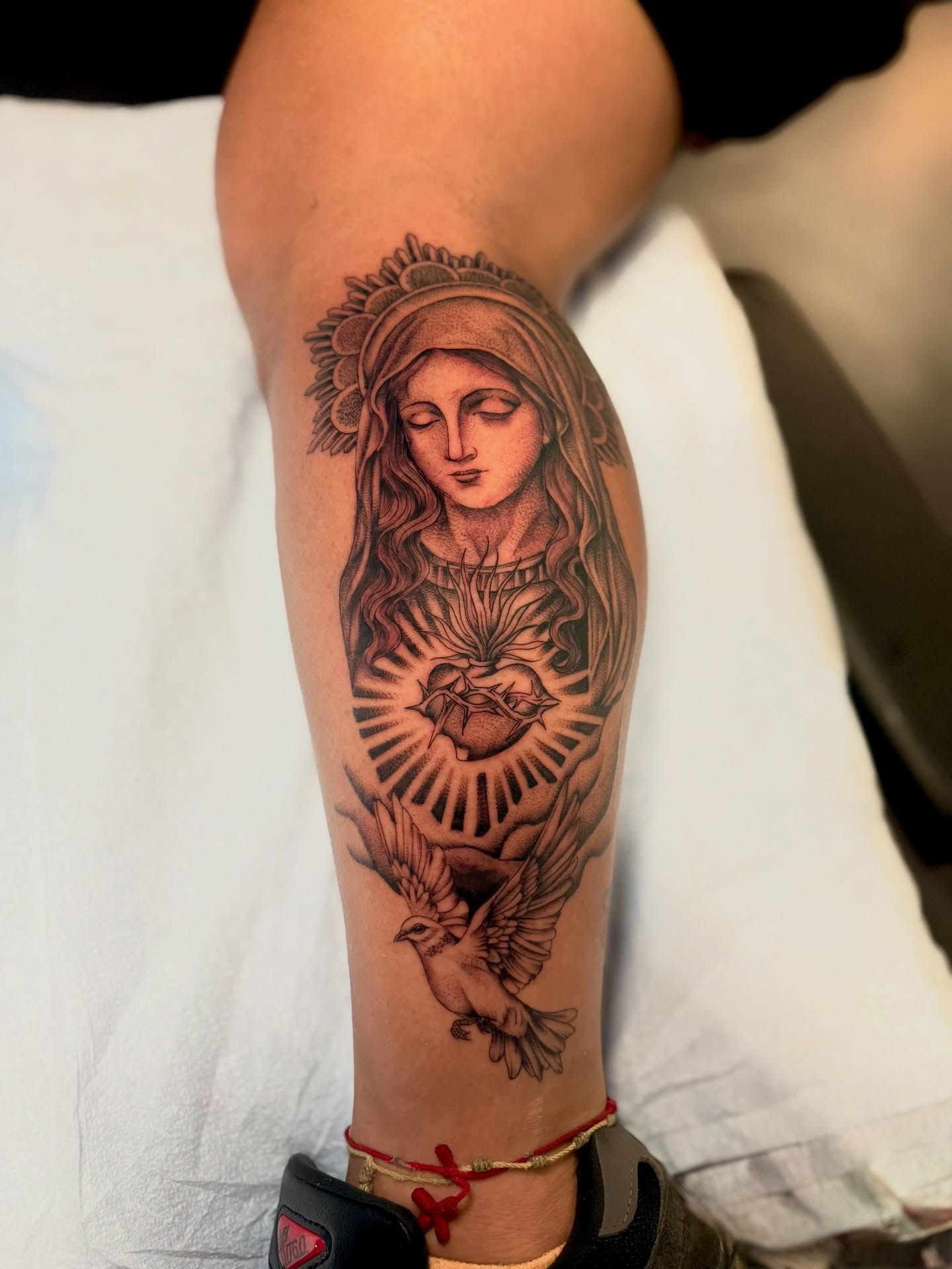 Religious figure with heart and dove realism tattoo on the forearm by Abby ✣ fineline and blackwork ✣