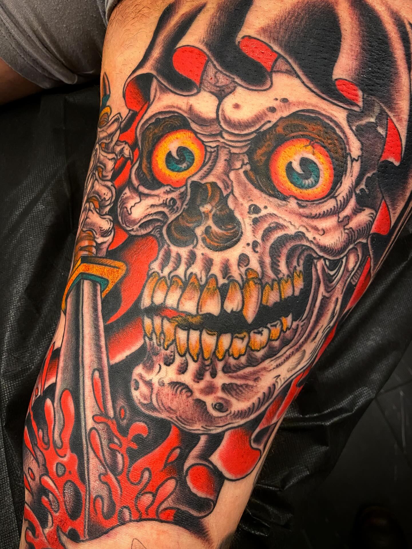 Skull with knife realism tattoo on the forearm by Adam Warmerdam, Los Angeles, California