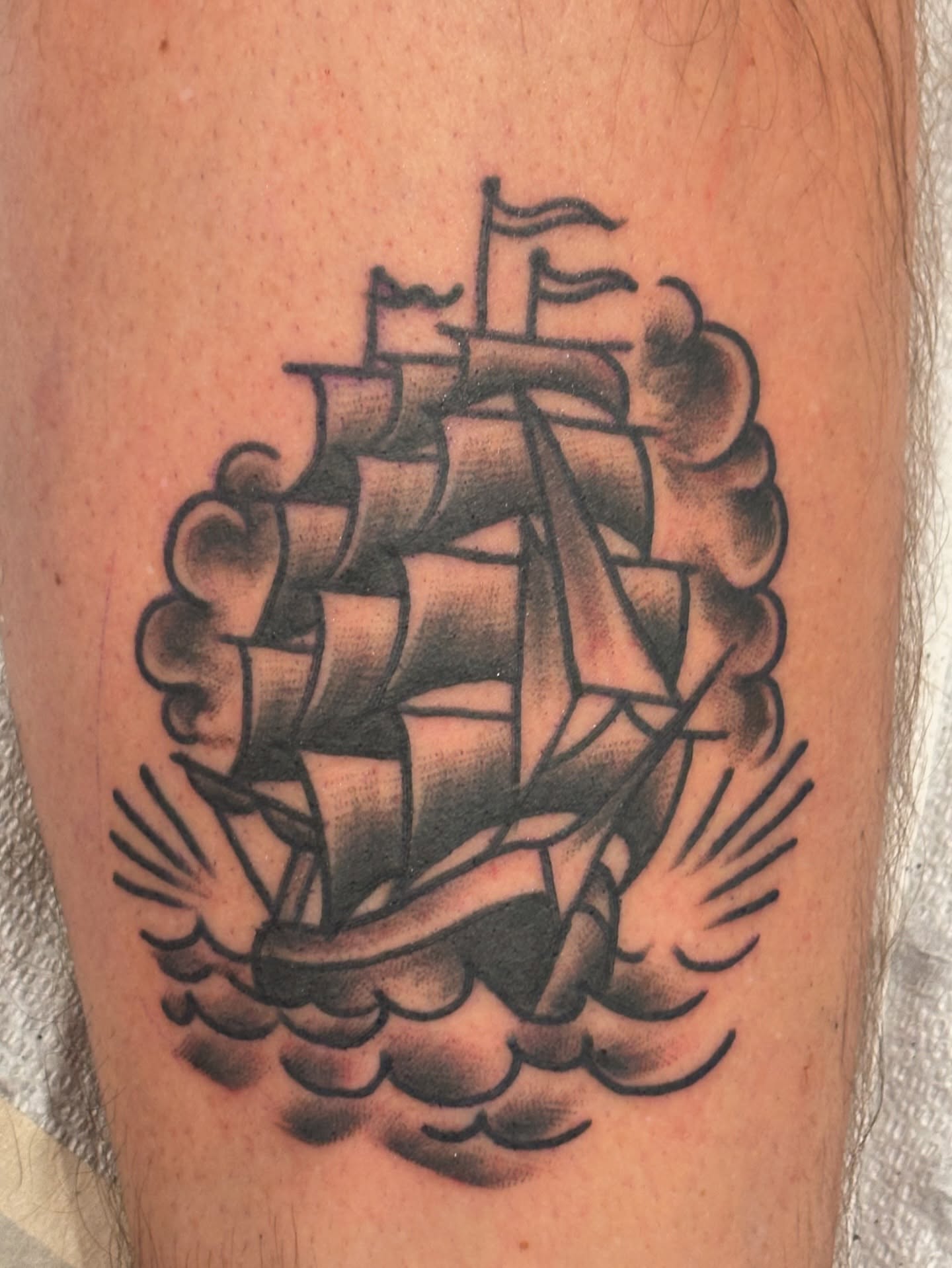 Ship black and grey tattoo on the forearm by Francis Cassidy
