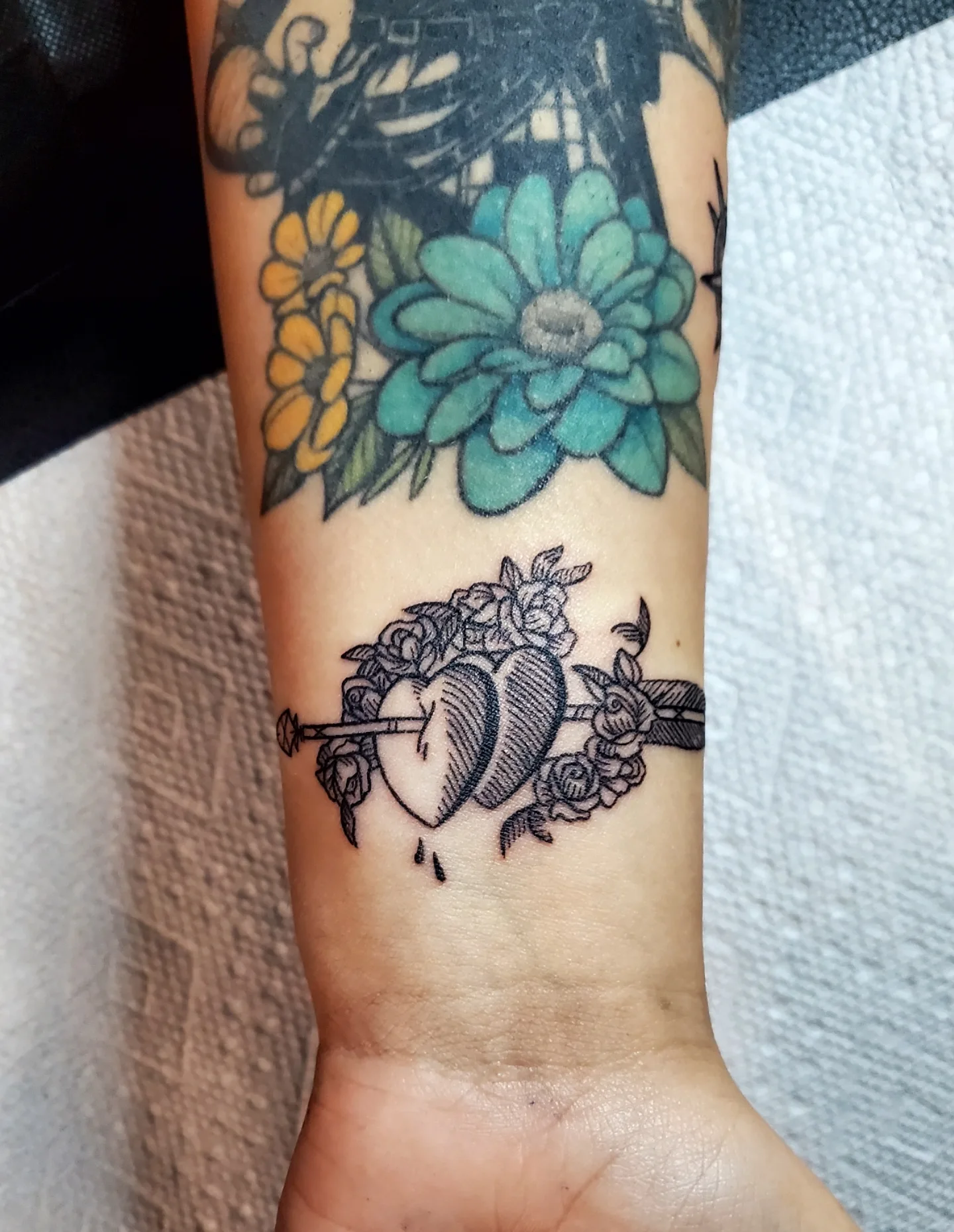 Flowers and apples black and grey tattoo on the forearm by Shailey Pasquale