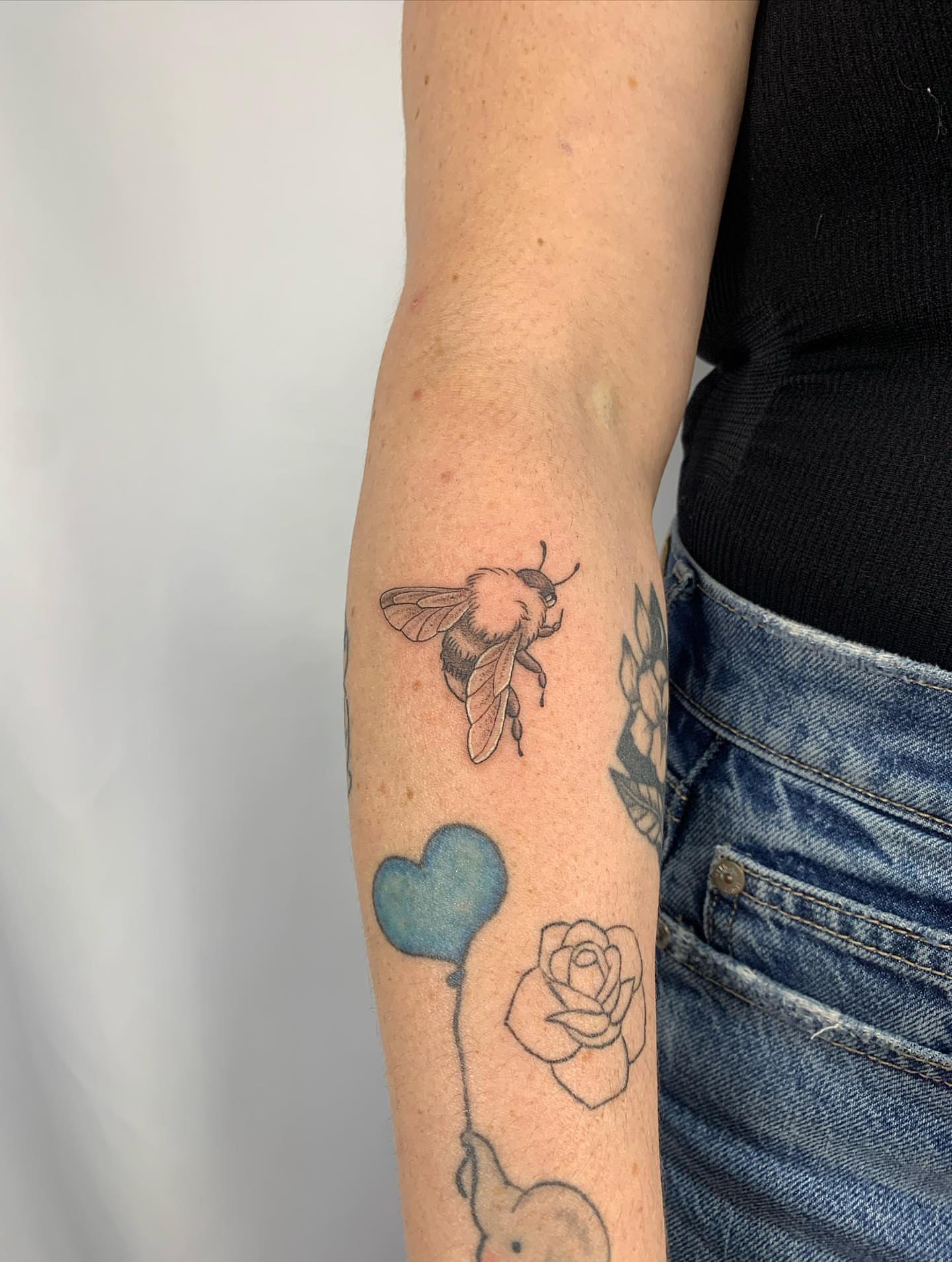 Bee black and grey tattoo on the forearm by ⊹ Avery Peterson ⊹