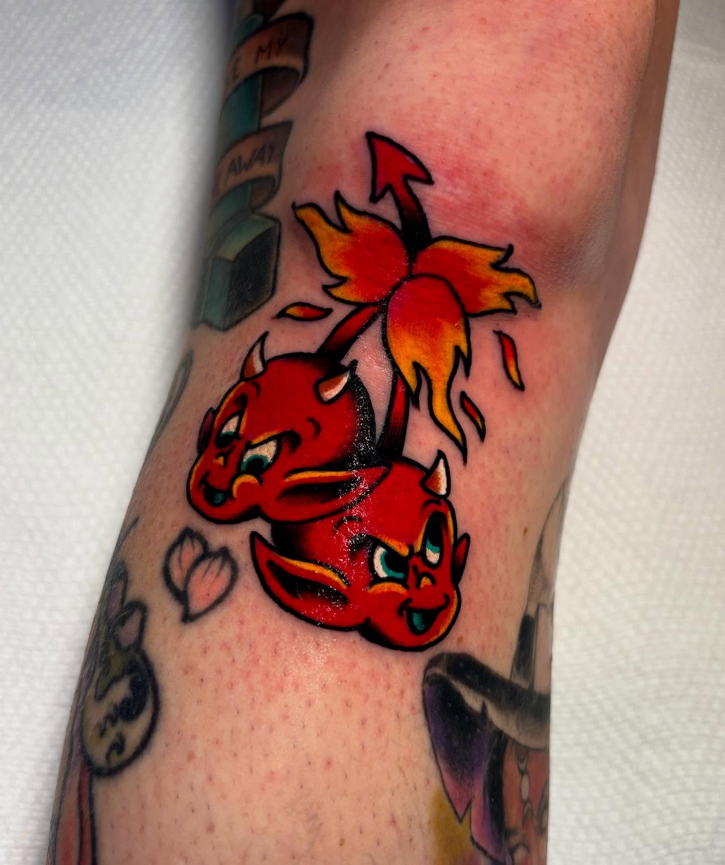 Red devils American traditional tattoo on the forearm by Mickey Putillo, Charlotte, North Carolina