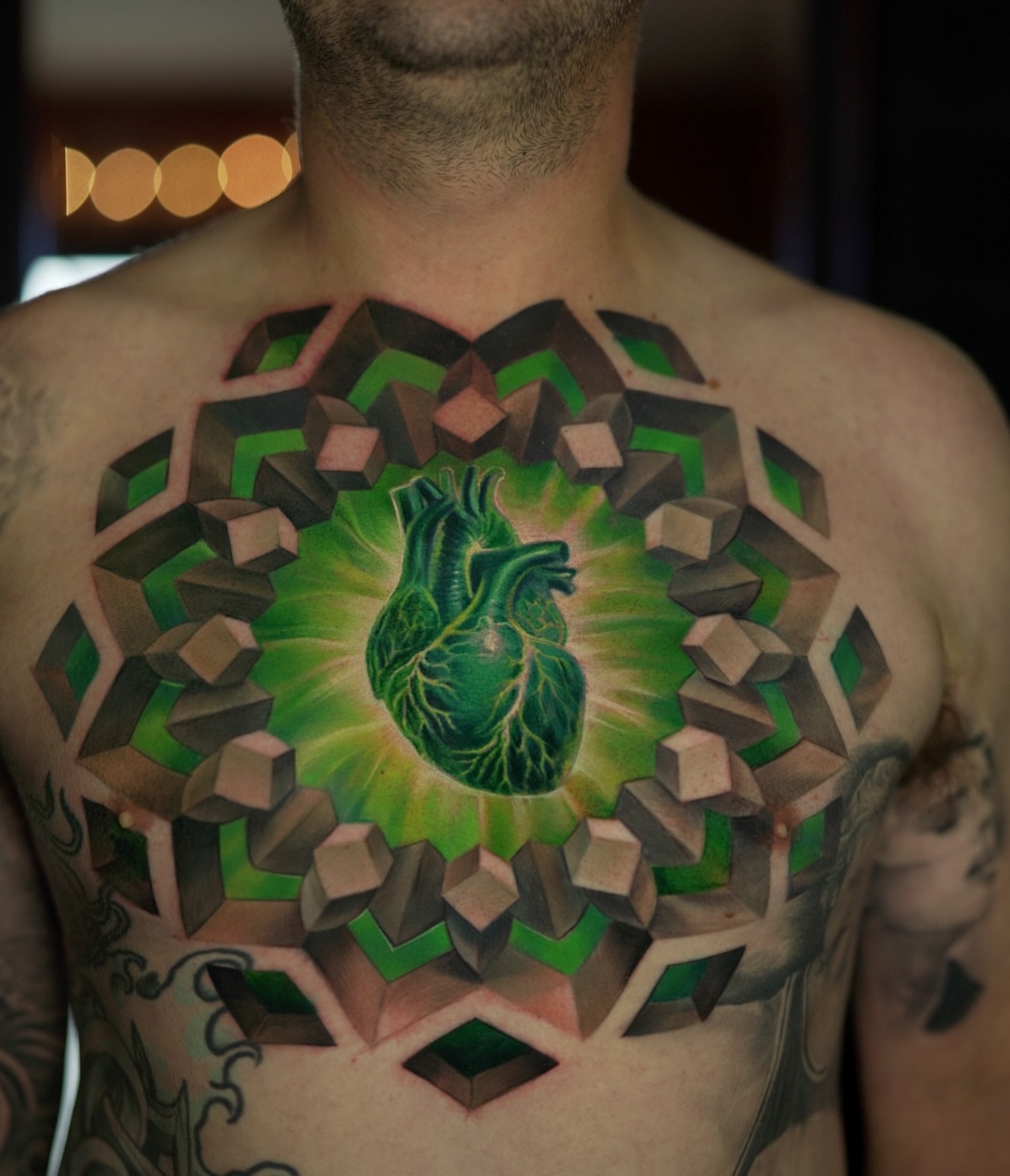 Heart geometric tattoo on the chest by Jesse Rix