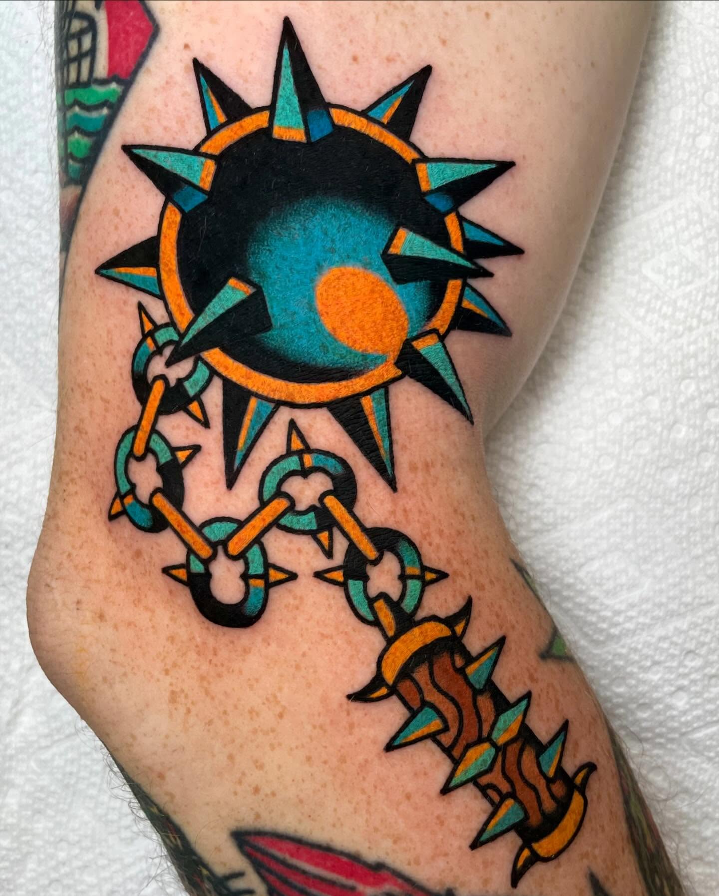 Sun and chain American traditional tattoo on the forearm by Ryan McDonald