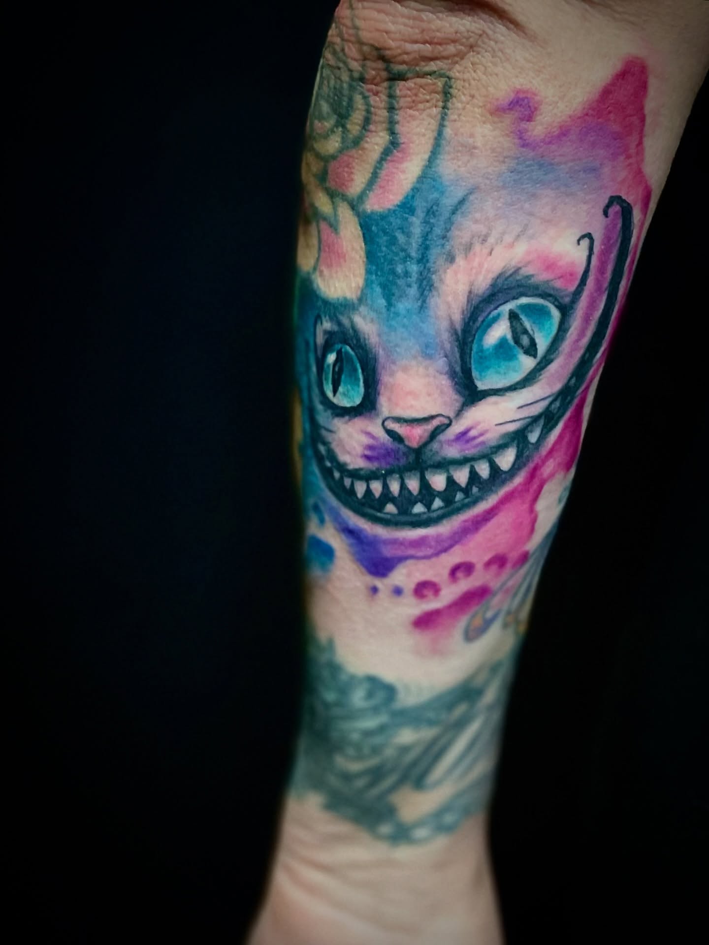 Cheshire Cat watercolor tattoo on the forearm by Will McCoy (Tattooist), Murray, Utah