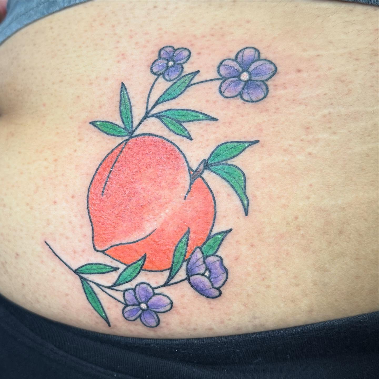 Peach and flowers new school tattoo on the ribs by Erica Rose π€