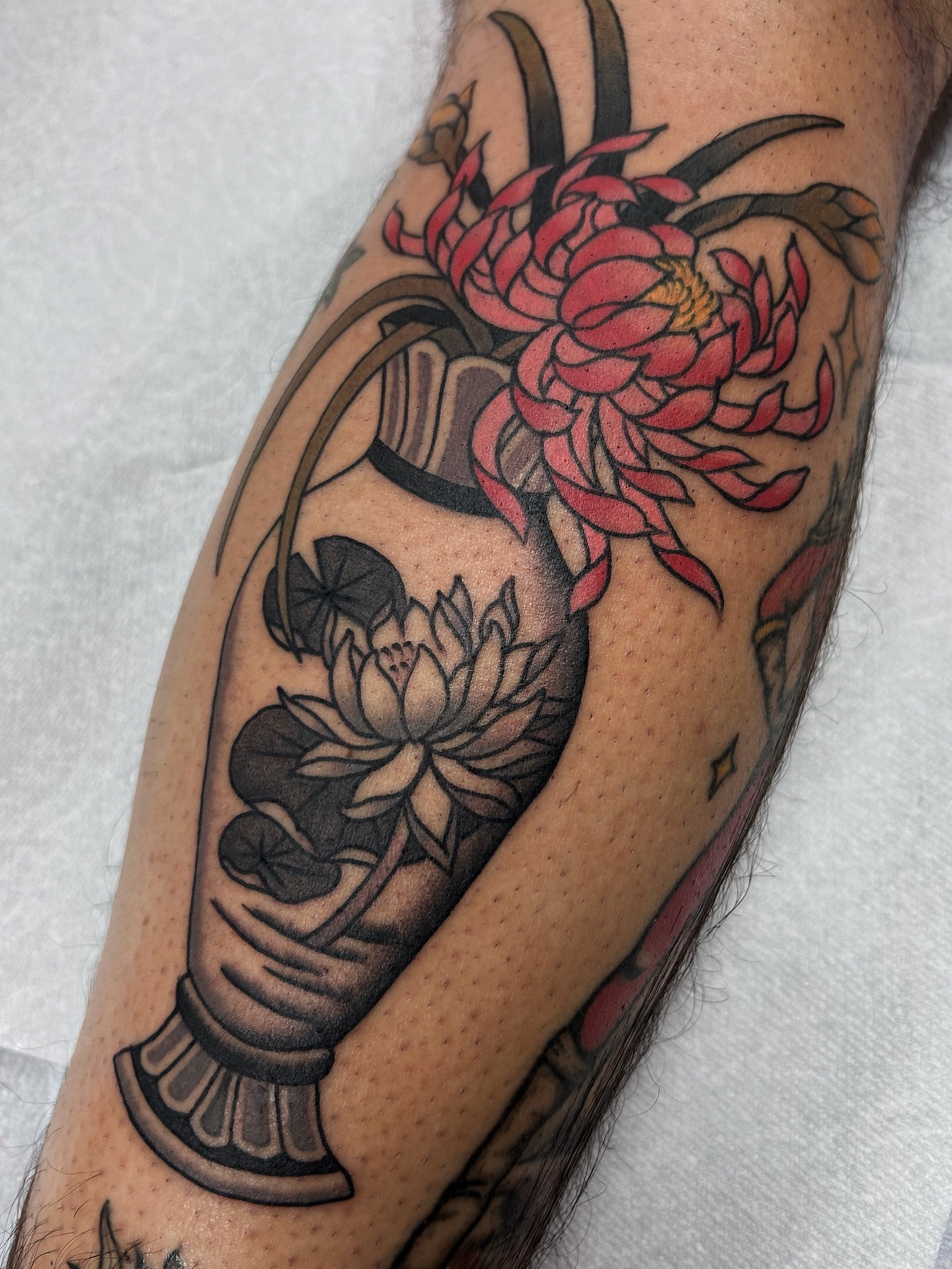 Lotus flowers black and grey tattoo on the forearm by Jade McKenzie, Temecula, California