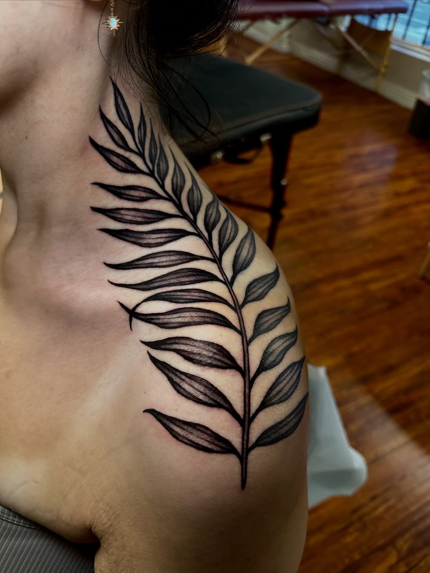 Fern leaf black and grey tattoo on the shoulder by Marisa Biddle