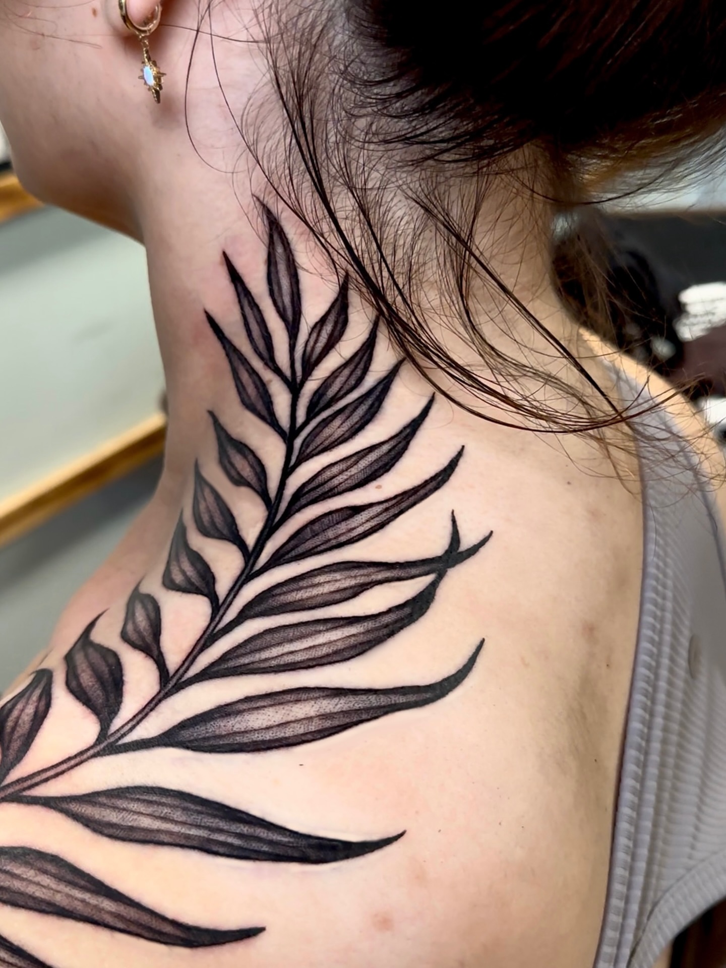 Fern leaf black and grey tattoo on the shoulder by Marisa Biddle
