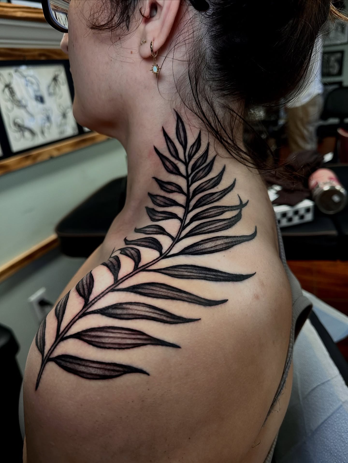 Fern leaf black and grey tattoo on the shoulder by Marisa Biddle