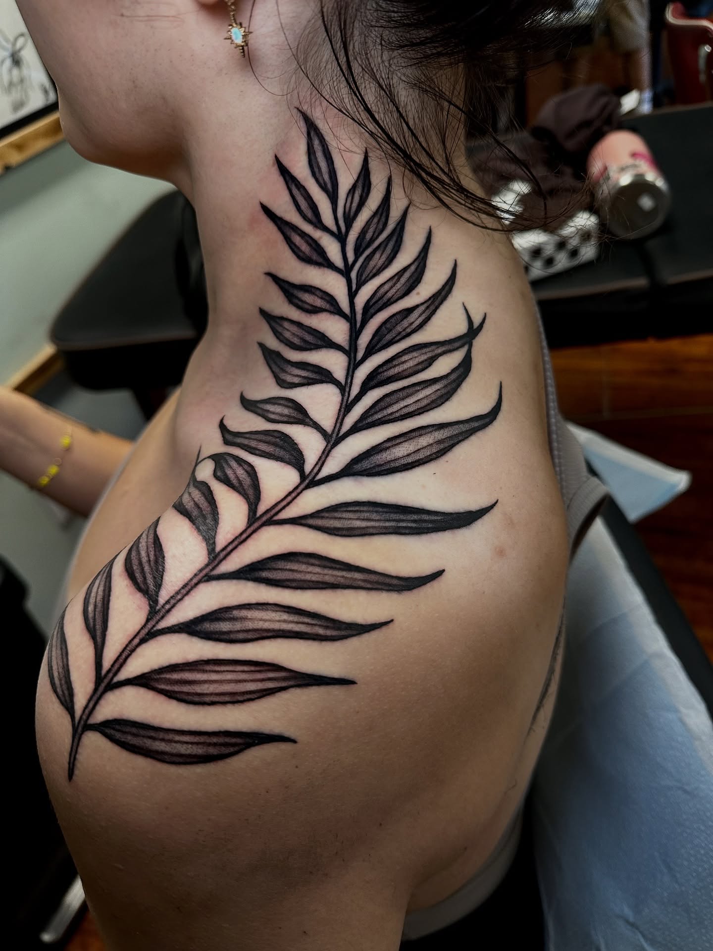 Fern leaf black and grey tattoo on the shoulder by Marisa Biddle