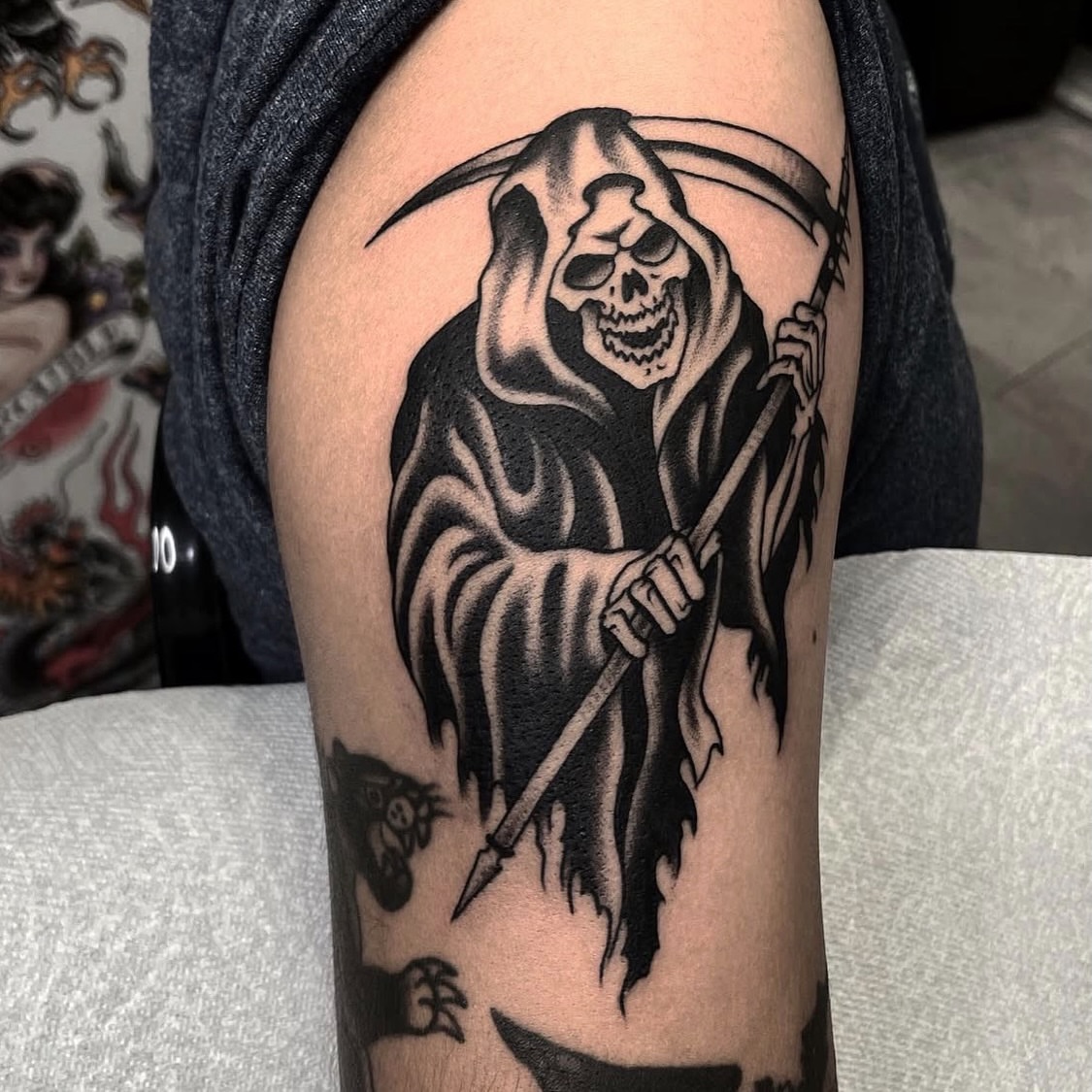 Grim reaper black and grey tattoo on the upper arm by Dakota Jenner