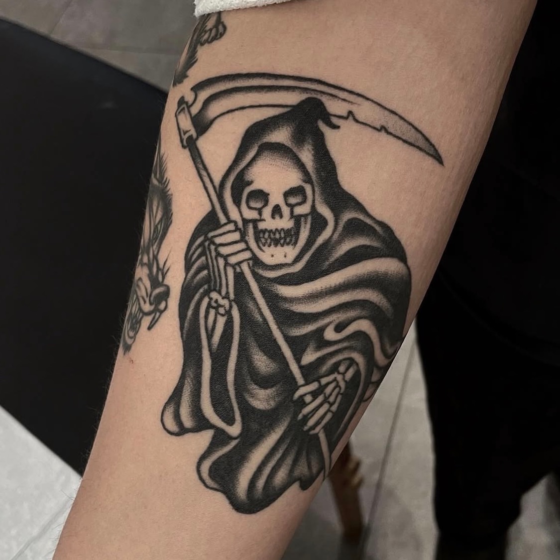 Grim reaper black and grey tattoo on the forearm by Dakota Jenner