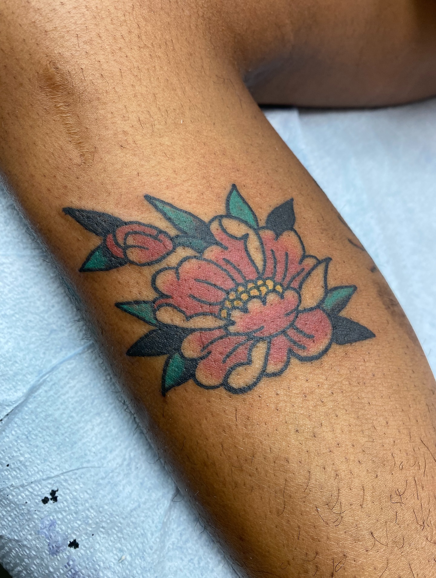 Floral bouquet American traditional tattoo on the forearm by Mike Tapia