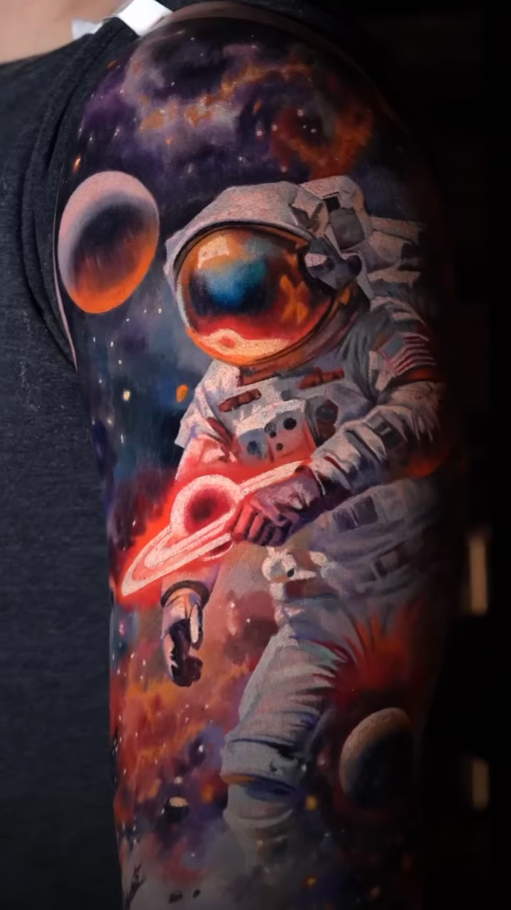 Astronaut in space realism tattoo by Slava Bodrov