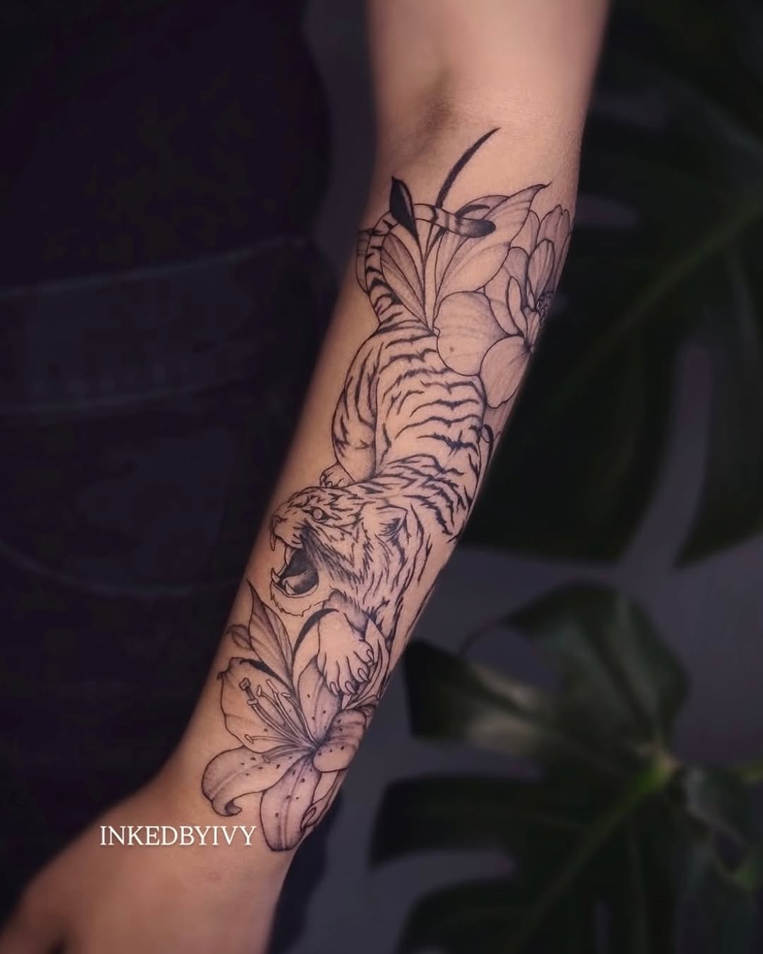Tiger and lilies realism tattoo on the forearm by IVY