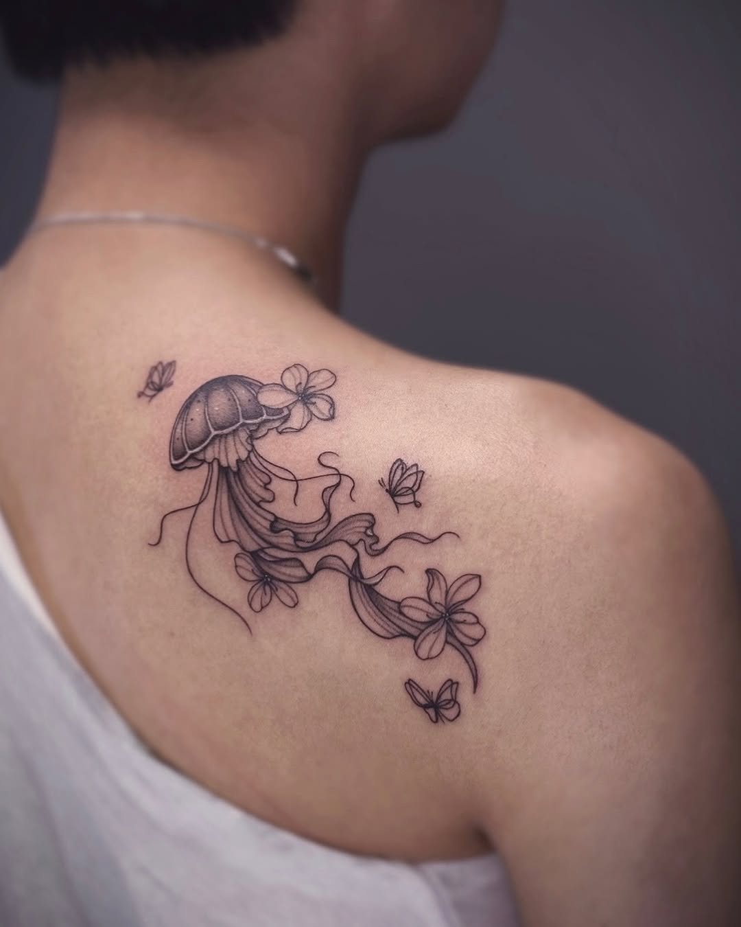 Jellyfish and butterflies blackwork tattoo on the shoulder by IVY