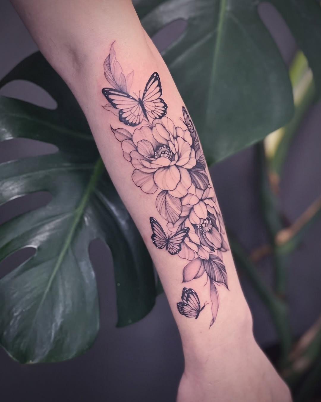 Flowers and butterflies dotwork tattoo on the forearm by IVY