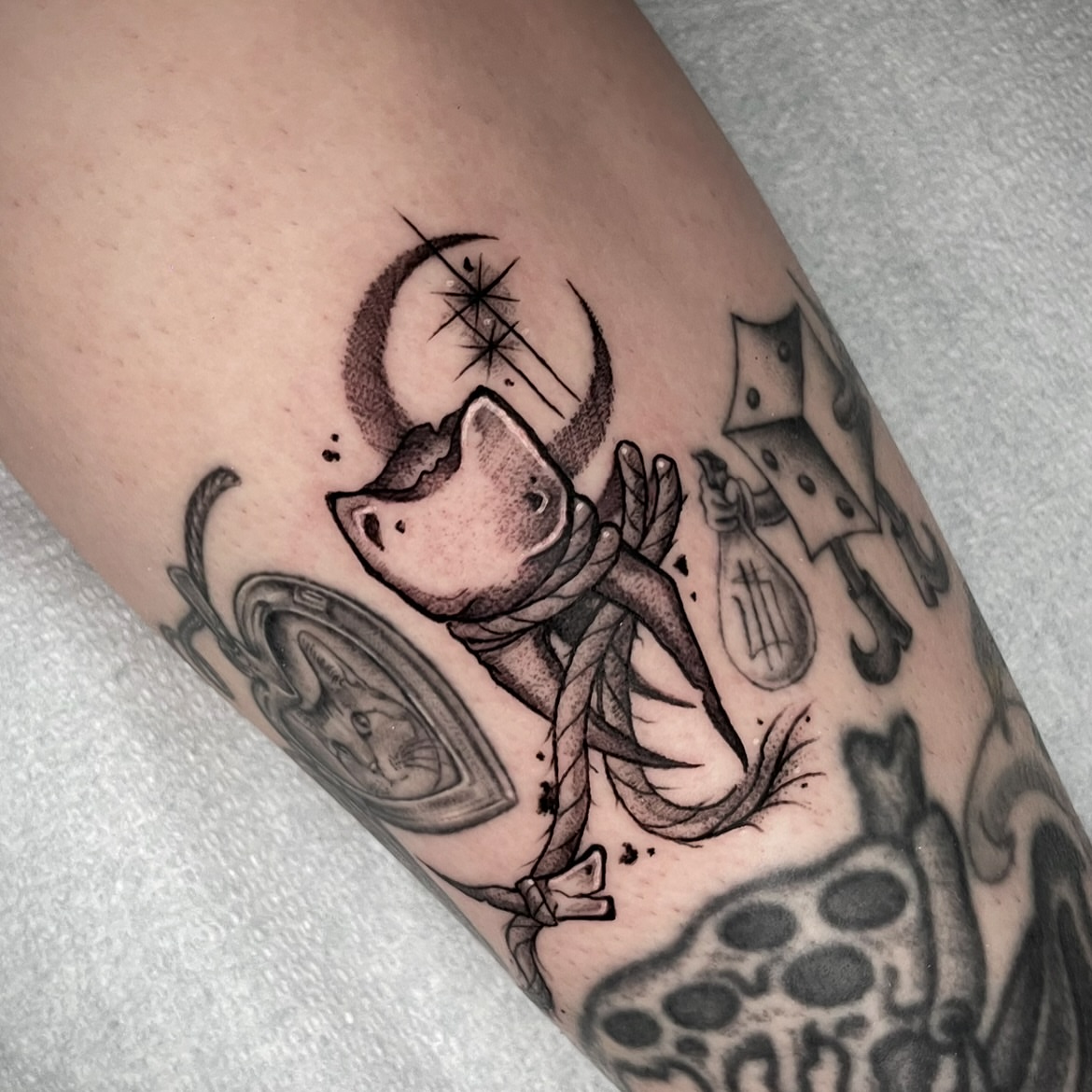 Cat and moon black and grey tattoo on the forearm by Kathryn the Tooth Collector