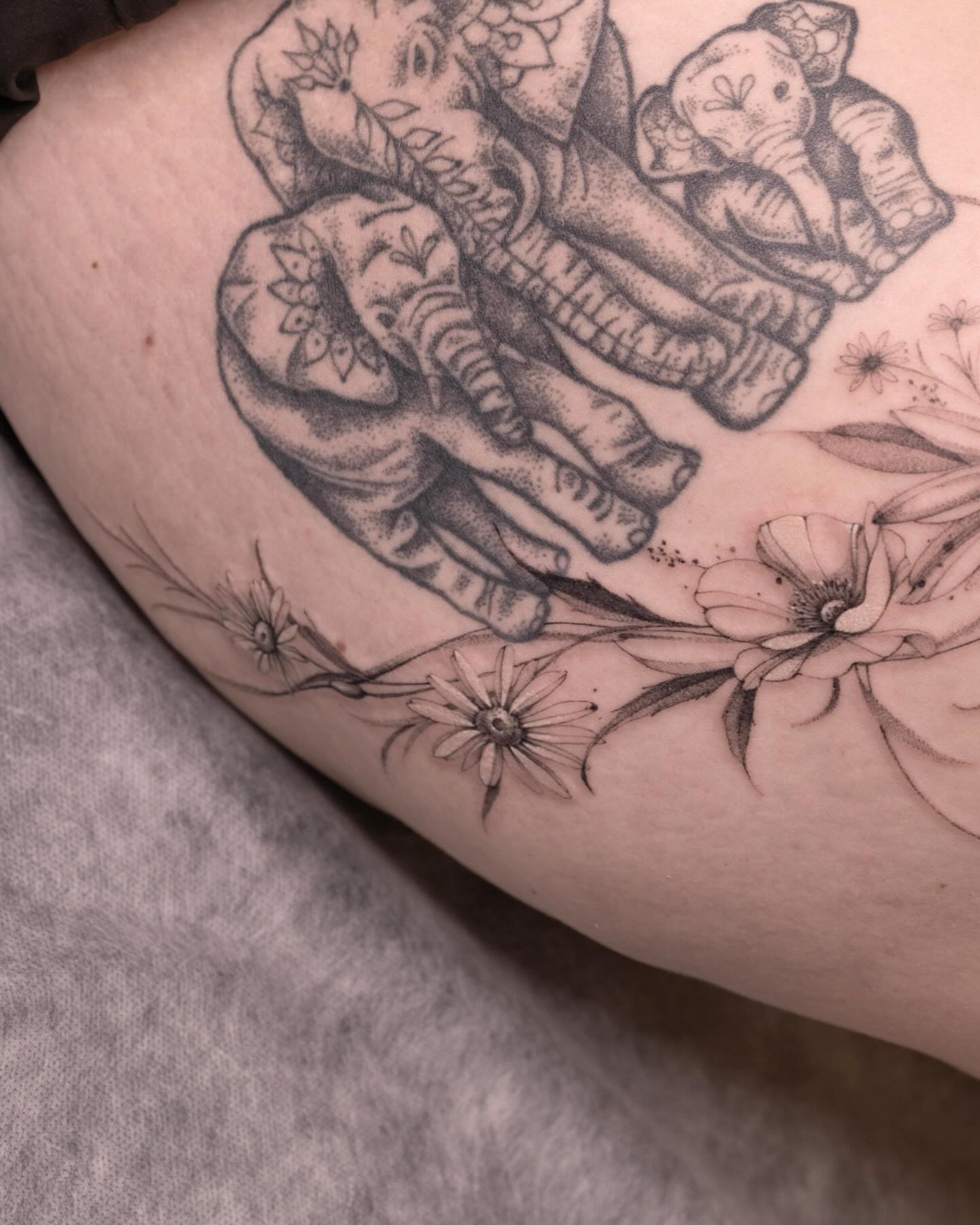 Elephants and flowers dotwork tattoo on the thigh by Tattooist hea