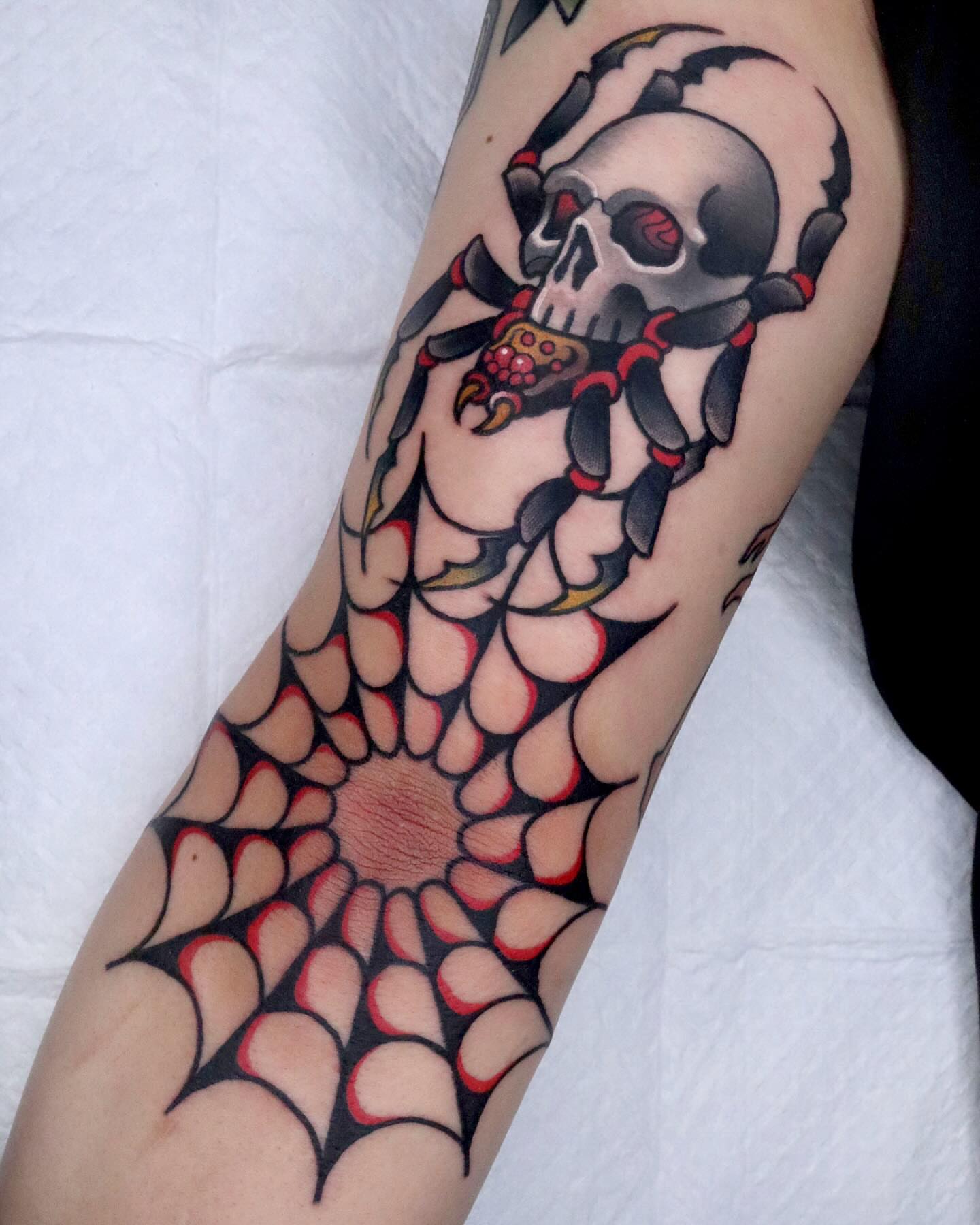 Skull with spiderweb American traditional tattoo on the forearm by 부산타투
