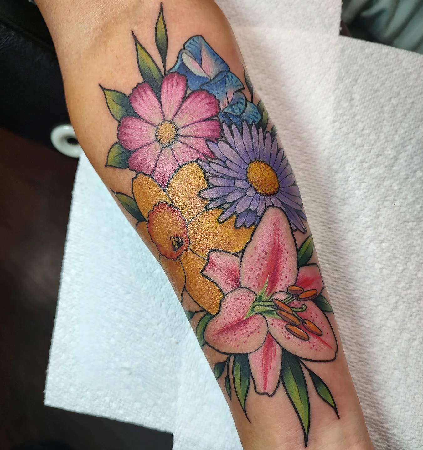 Floral bouquet new school tattoo on the forearm by Jennifer Fowler