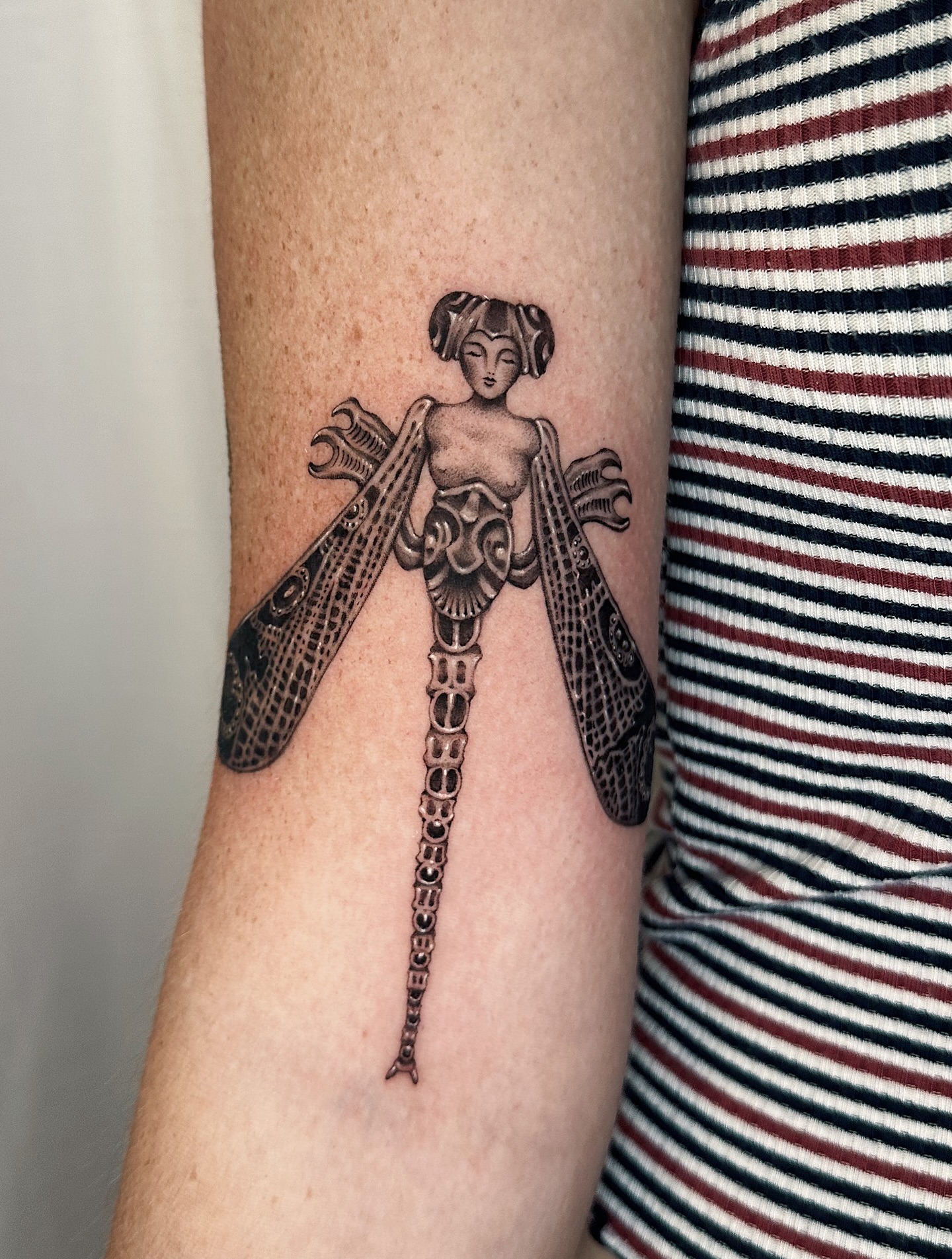 Dragonfly woman black and grey tattoo on the forearm by Lauryn Jenesis