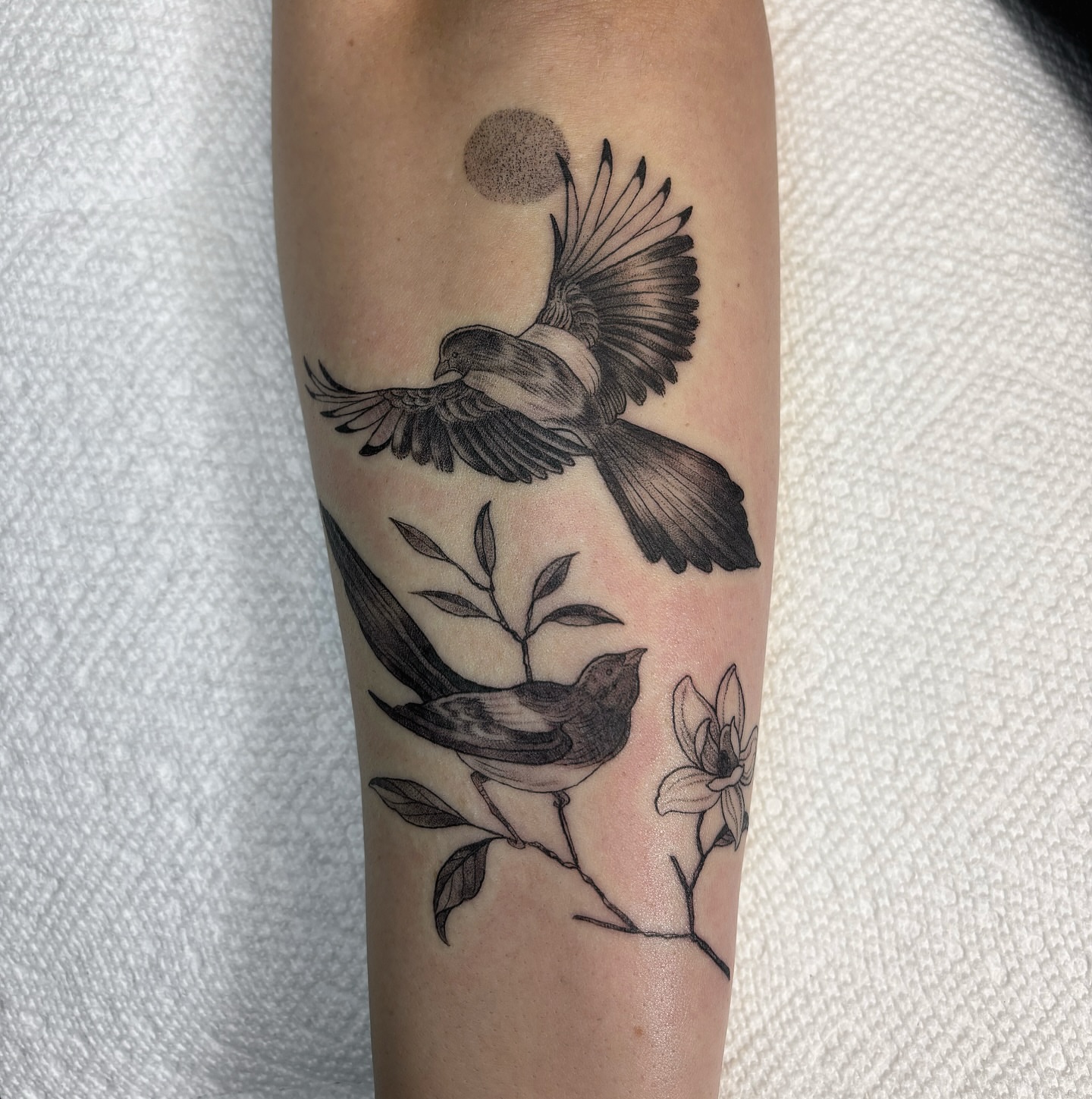 Birds and flowers realism tattoo on the forearm by Fineline tattoos by Kinsey