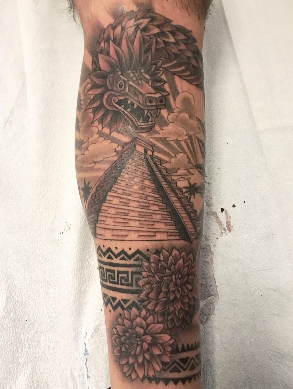 Pyramid with feathered serpent neo-traditional tattoo on the forearm by Miles Maniaci, Chicago, Illinois