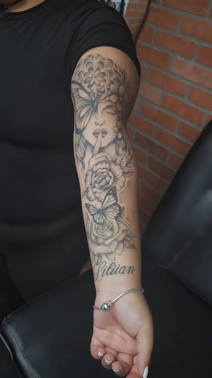 Woman with flowers and butterfly realism tattoo by Marvin Osorno