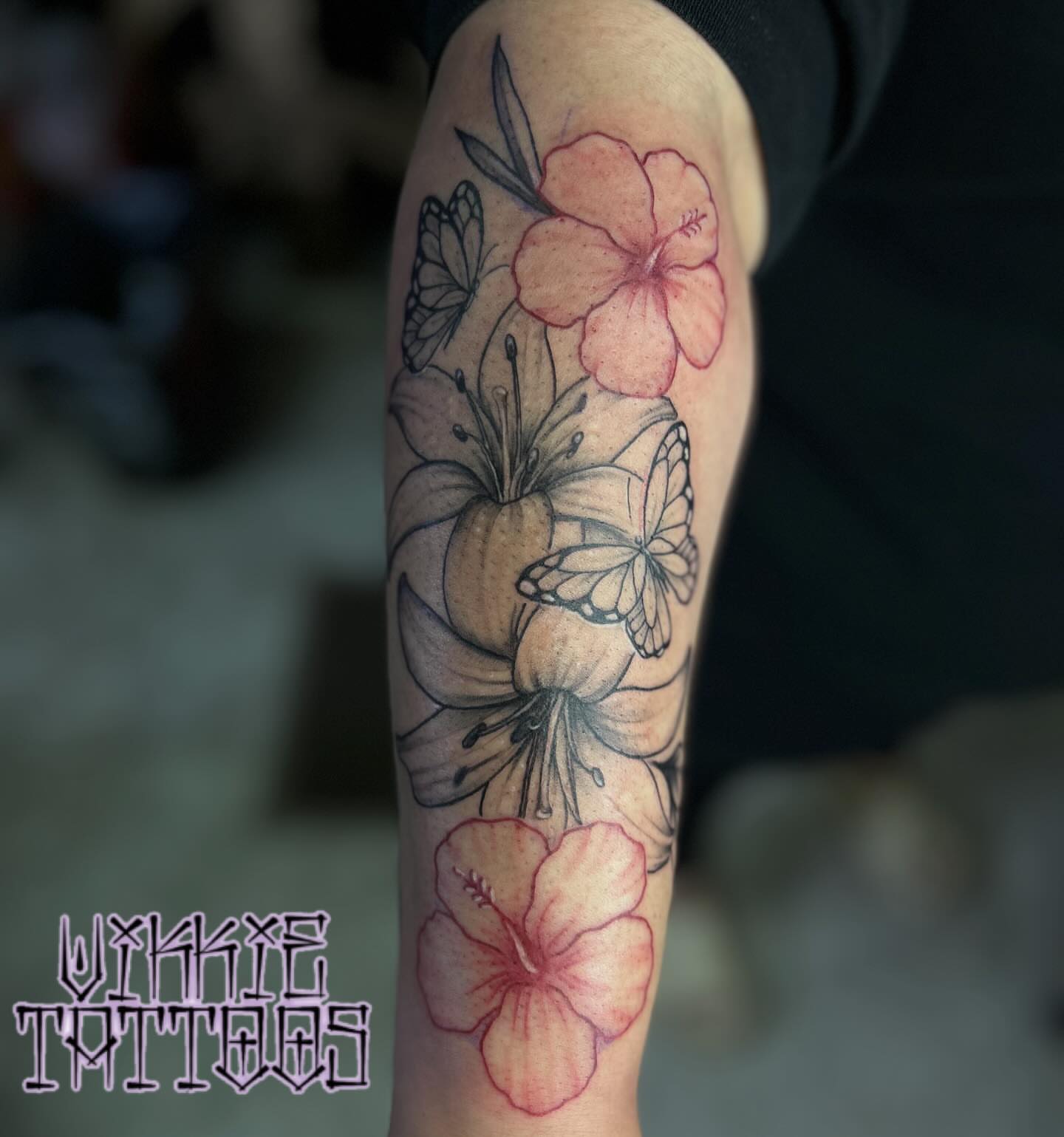 Flowers and butterflies watercolor tattoo on the forearm by Victoria Mendez