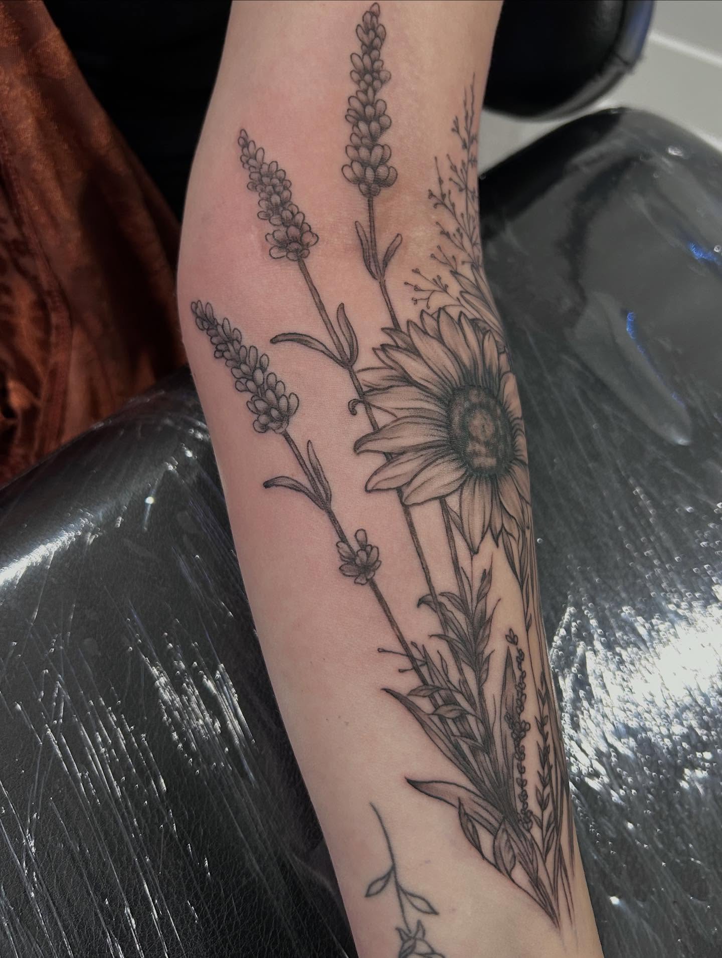 Sunflower and lavender black and grey tattoo on the forearm by Jbtattoo Artistry
