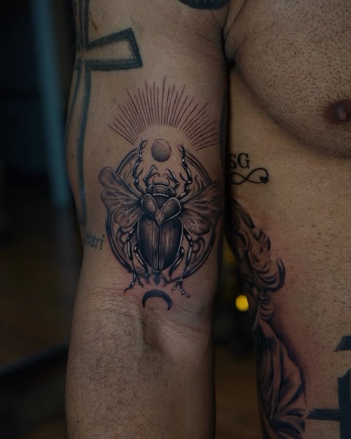 Scarab beetle geometric tattoo on the forearm by Davier Del Castillo