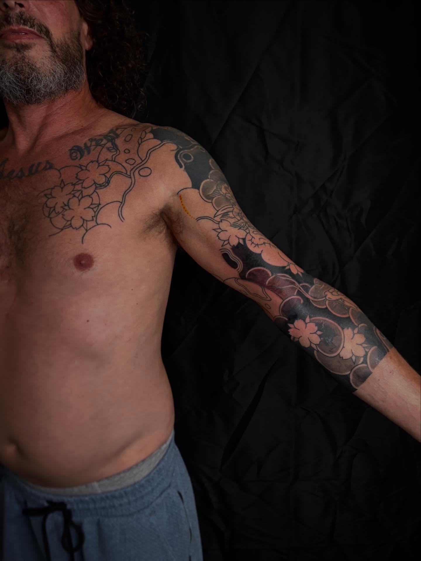 Cherry blossoms japanese irezumi tattoo on the upper arm by Zach Hendrickson