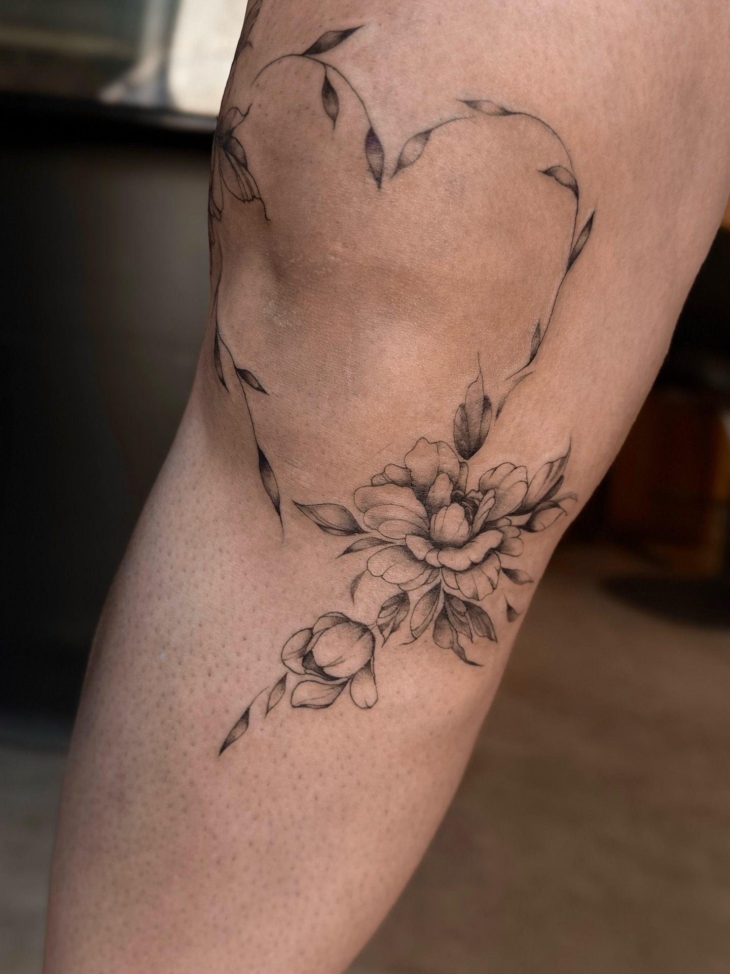 Peony and heart black and grey tattoo on the thigh by Lily K.