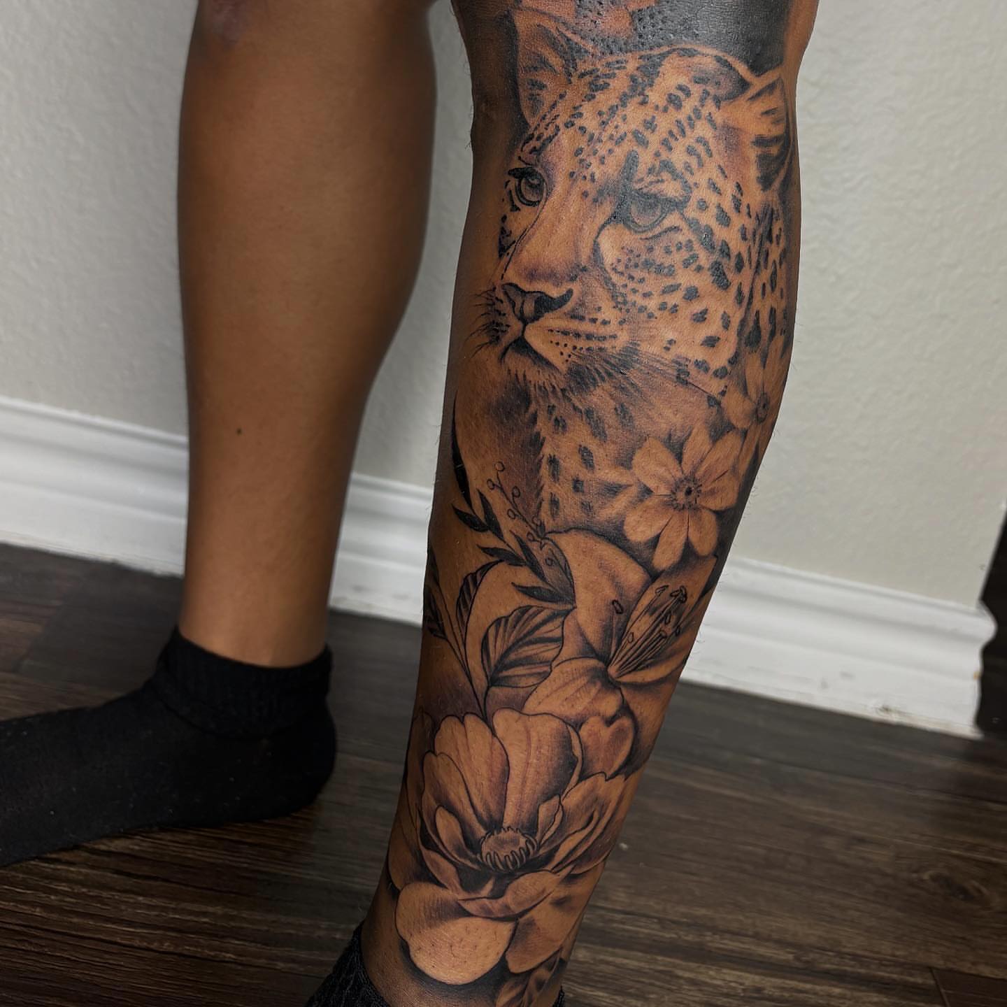 Leopard and flowers realism tattoo on the calf by ✧ Dallas Tattoo Artist  ✧