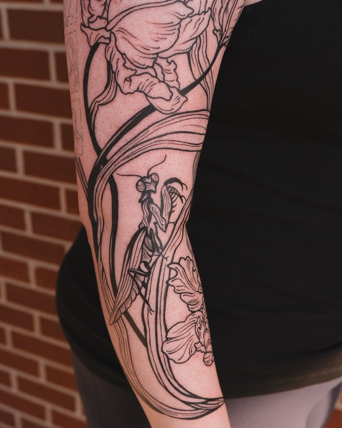 Insect and floral realism tattoo on the forearm by Renee (Koi) Vance