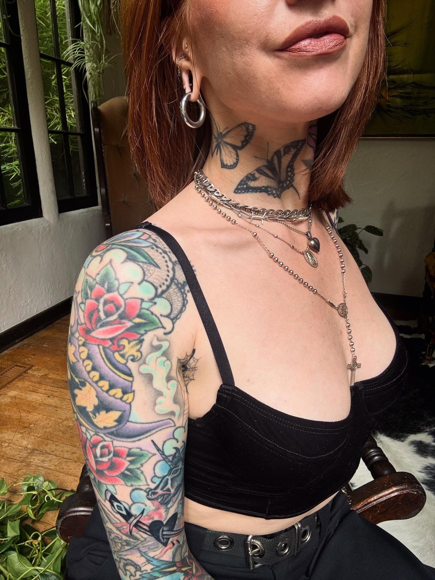 Floral skull American traditional tattoo on the upper arm by Victoria Bacon