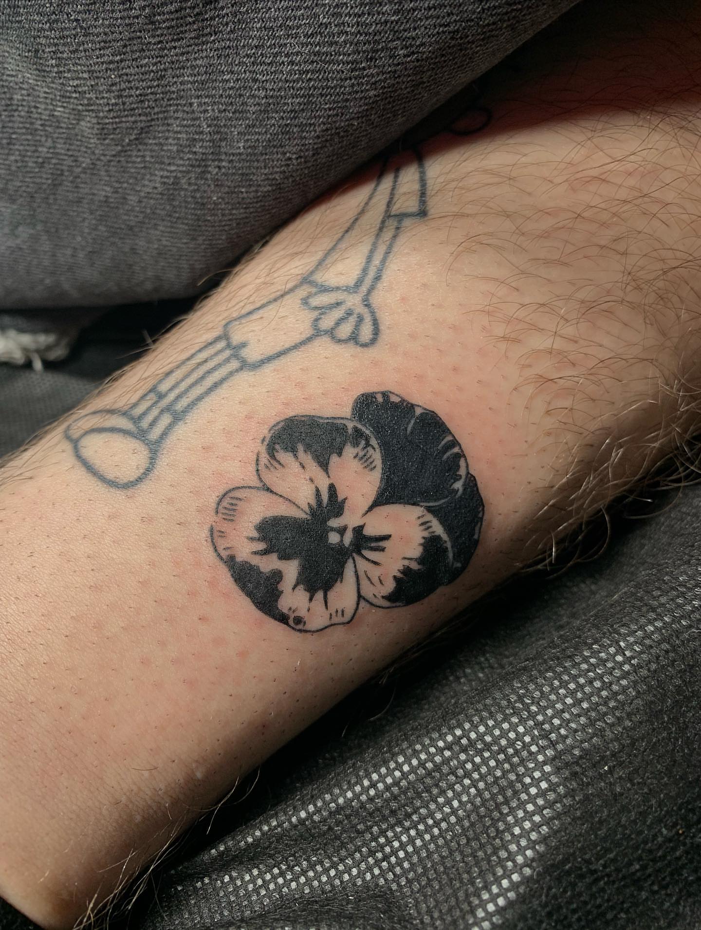 Pansy flower black and grey tattoo on the forearm by ⊹ Avery Peterson ⊹