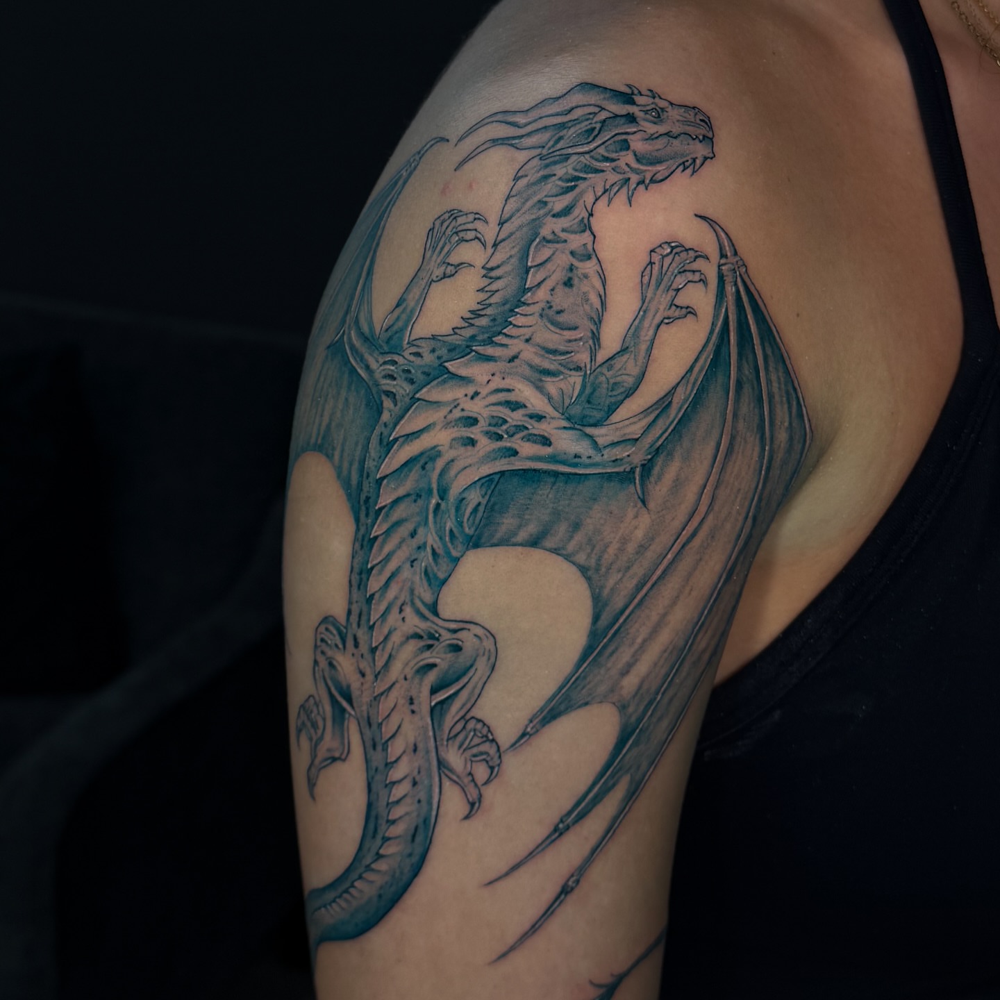 Dragon black and grey tattoo on the shoulder by Nicolas Herrera